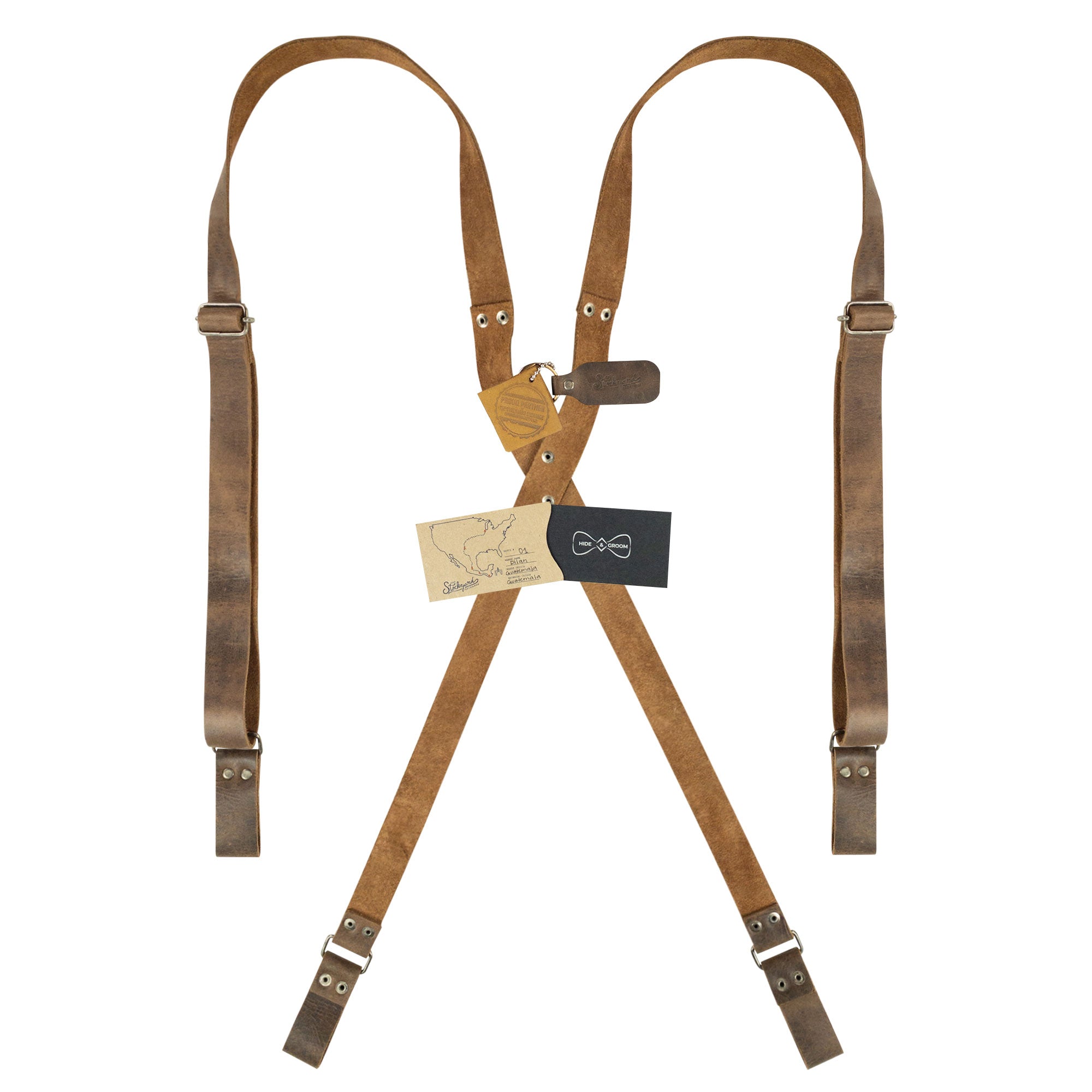 Riveted X Back Suspenders with Belt Loops by Hide & Groom, presented with care instructions and artisan tags. A perfect addition to any wardrobe, these heavy-duty, handmade full grain leather suspenders highlight the beauty of small batch production.