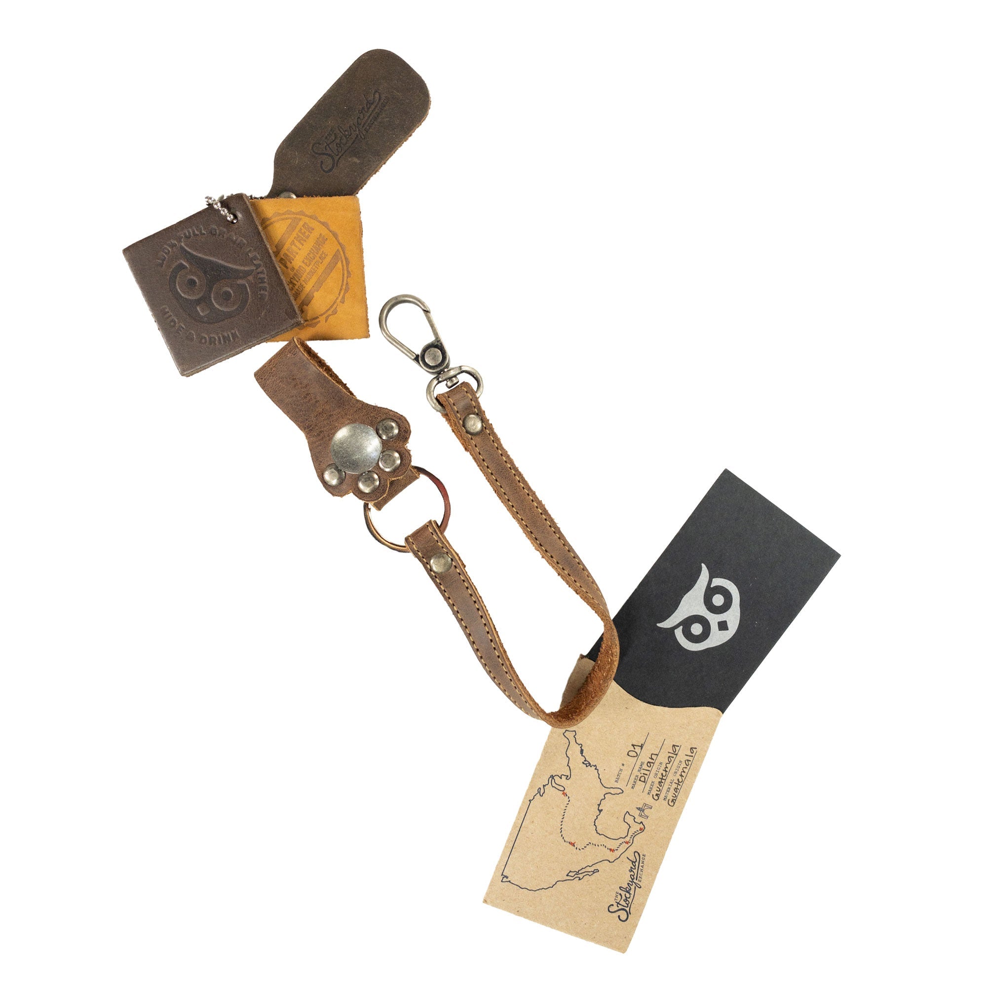 Unique Paw Lanyard by Hide & Drink displayed with care instructions and packaging. This Full Grain Leather accessory serves as a key holder organizer and a thoughtful gift, reflecting artisan craftsmanship and small batch production from La Antigua Guatemala & Oaxaca Mexico.