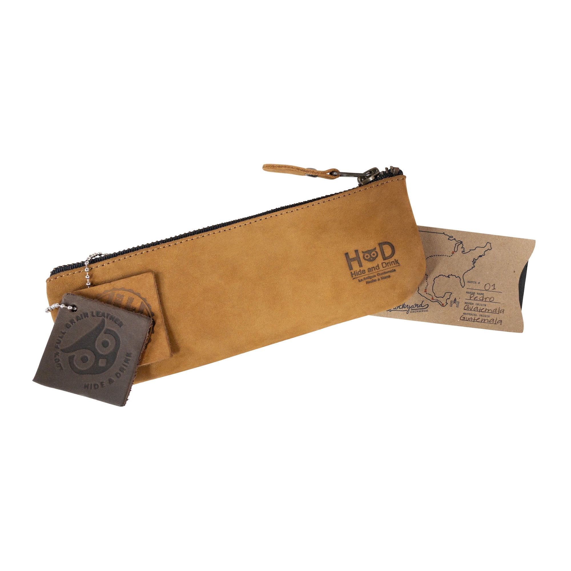Pencil Pouch by Hide & Drink featuring tags showcasing its craftsmanship. This rectangular pencil case is crafted from full grain leather, serving as a versatile pen and marker pouch for men and women. Handmade in La Antigua Guatemala, this classic style is ideal for artists.