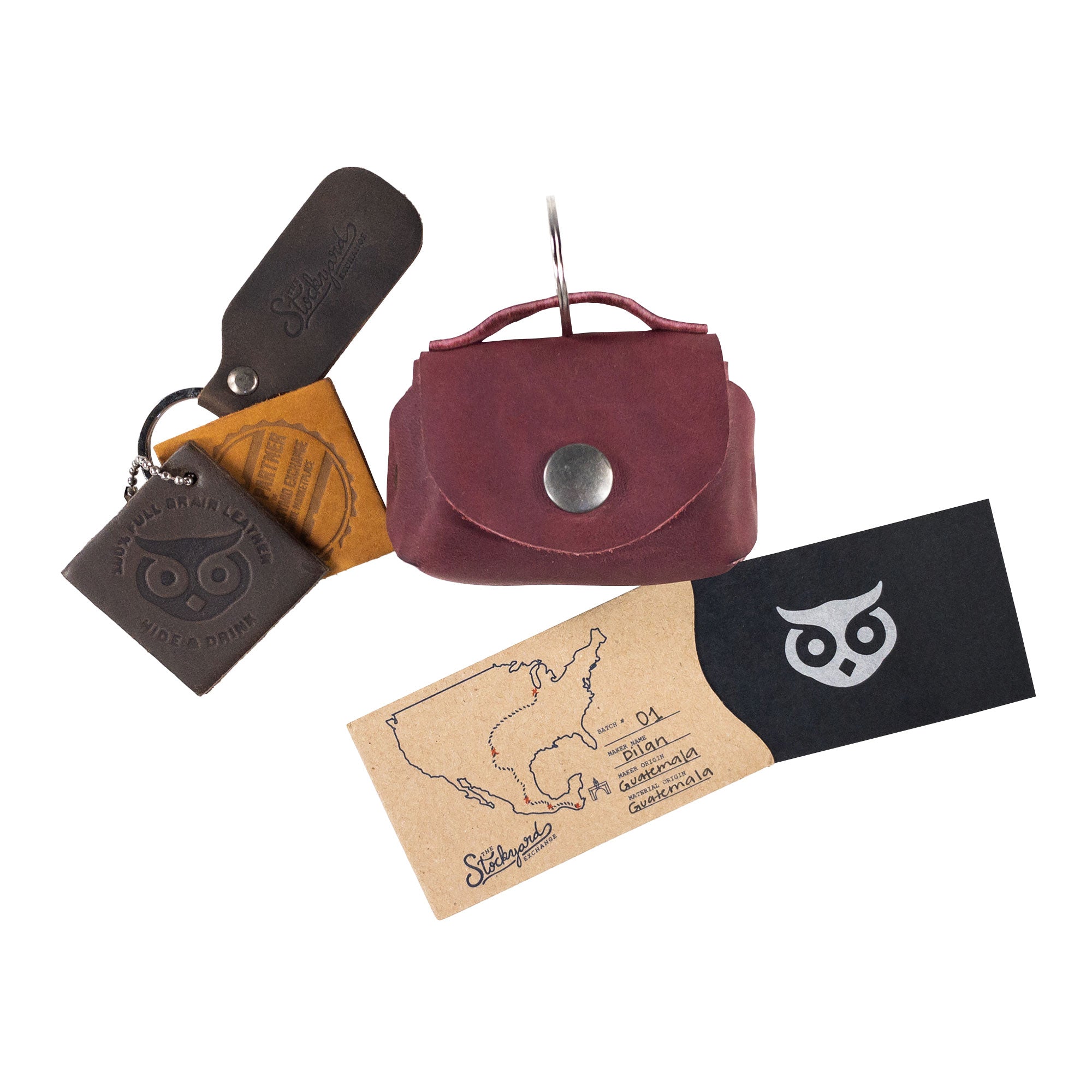 The Tiny Handbag Keychain by Hide & Drink alongside other artisanal items, showcasing its rustic charm and Full Grain Leather finish. Hand cut and hand sewn, this item embodies the spirit of small batch production from La Antigua Guatemala.