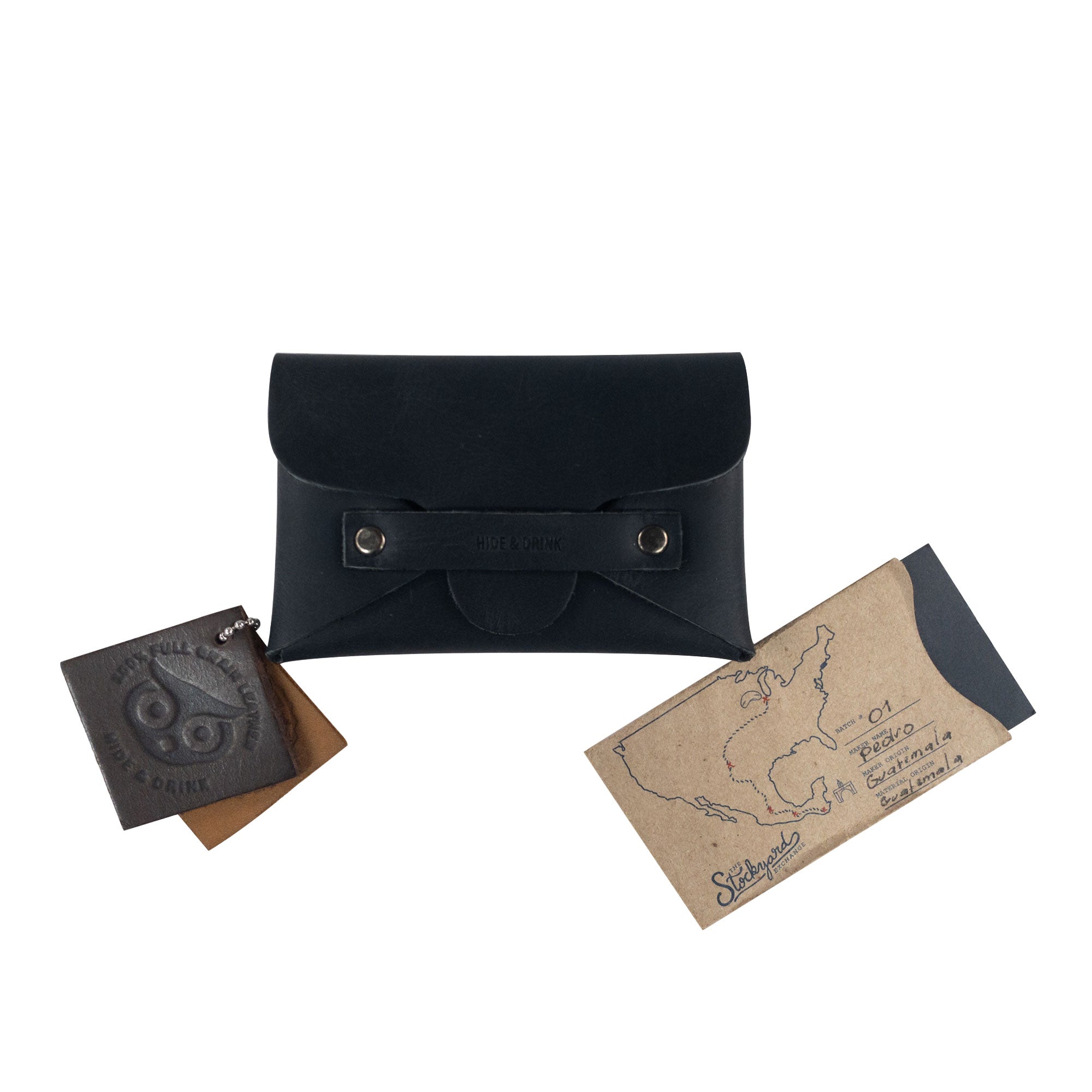 A Snapless Business Card Holder from Hide & Drink, stylishly placed with additional cards and envelopes, reflecting its comprehensive utility. This vintage wallet is suitable for both men and women, crafted from exquisite Full Grain Leather, functioning as a sturdy pouch and money organizer, showcasing artisan workmanship from La Antigua Guatemala and Oaxaca Mexico.