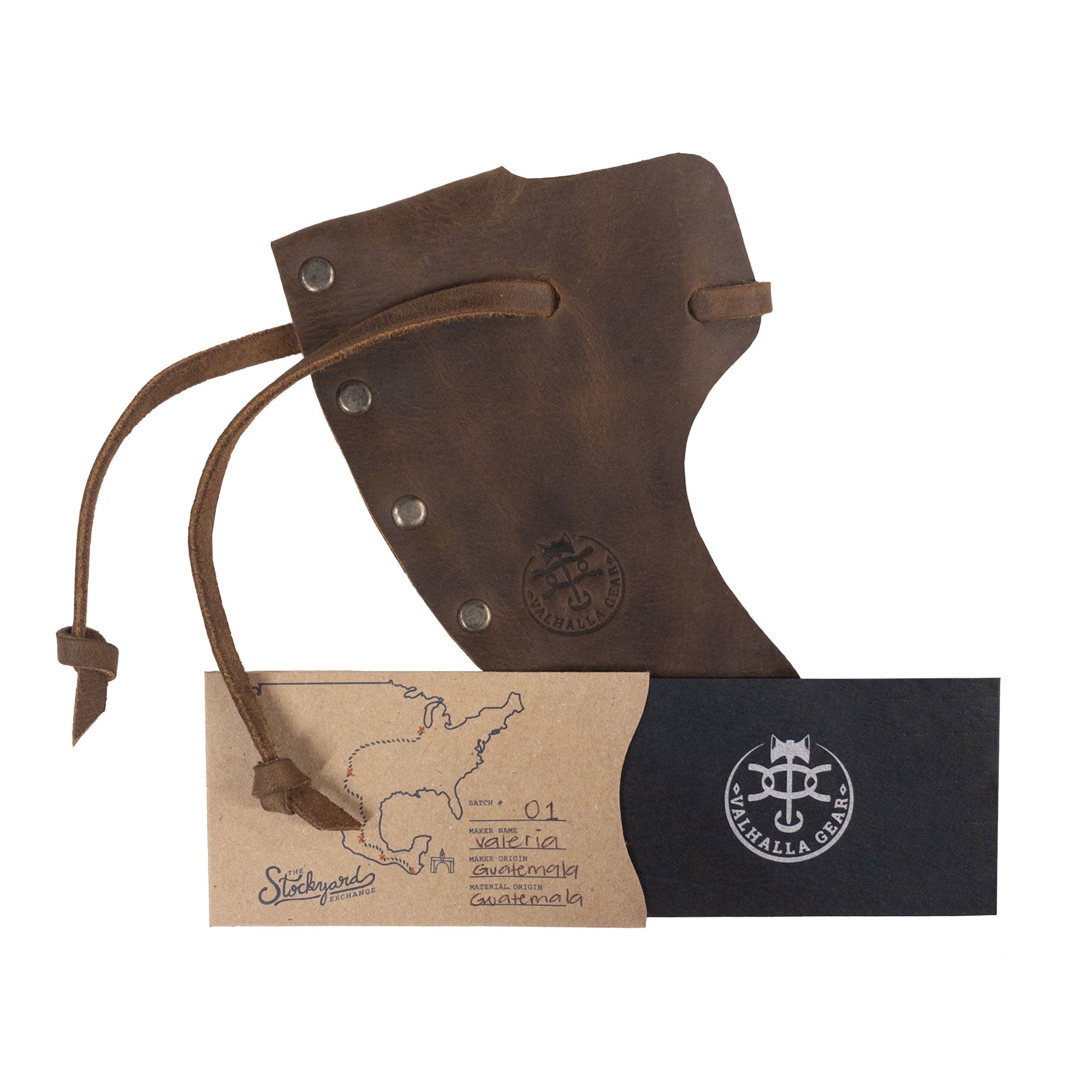 An elegant presentation of the Axe Head Sheath with String by Valhalla Gear, showcasing its packaging and craftsmanship. This full grain leather accessory is handmade in La Antigua Guatemala, designed for bikers and outdoor enthusiasts looking for quality and functionality.