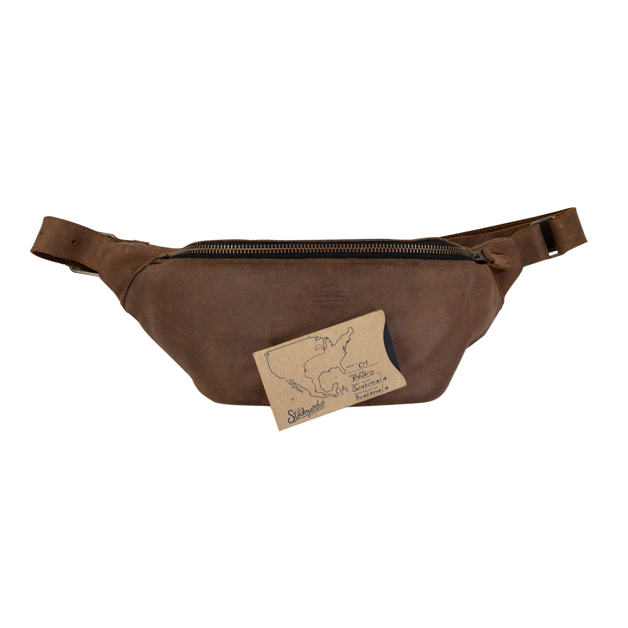 Zippered Fanny Pack by Leather Nomad in a natural setting. This handmade bag is crafted from full grain leather and serves as a stylish waist bag for travel, offering storage for money and phone. Artisan quality is evident in its small batch production, hand cut, and hand sewn features from La Antigua Guatemala.