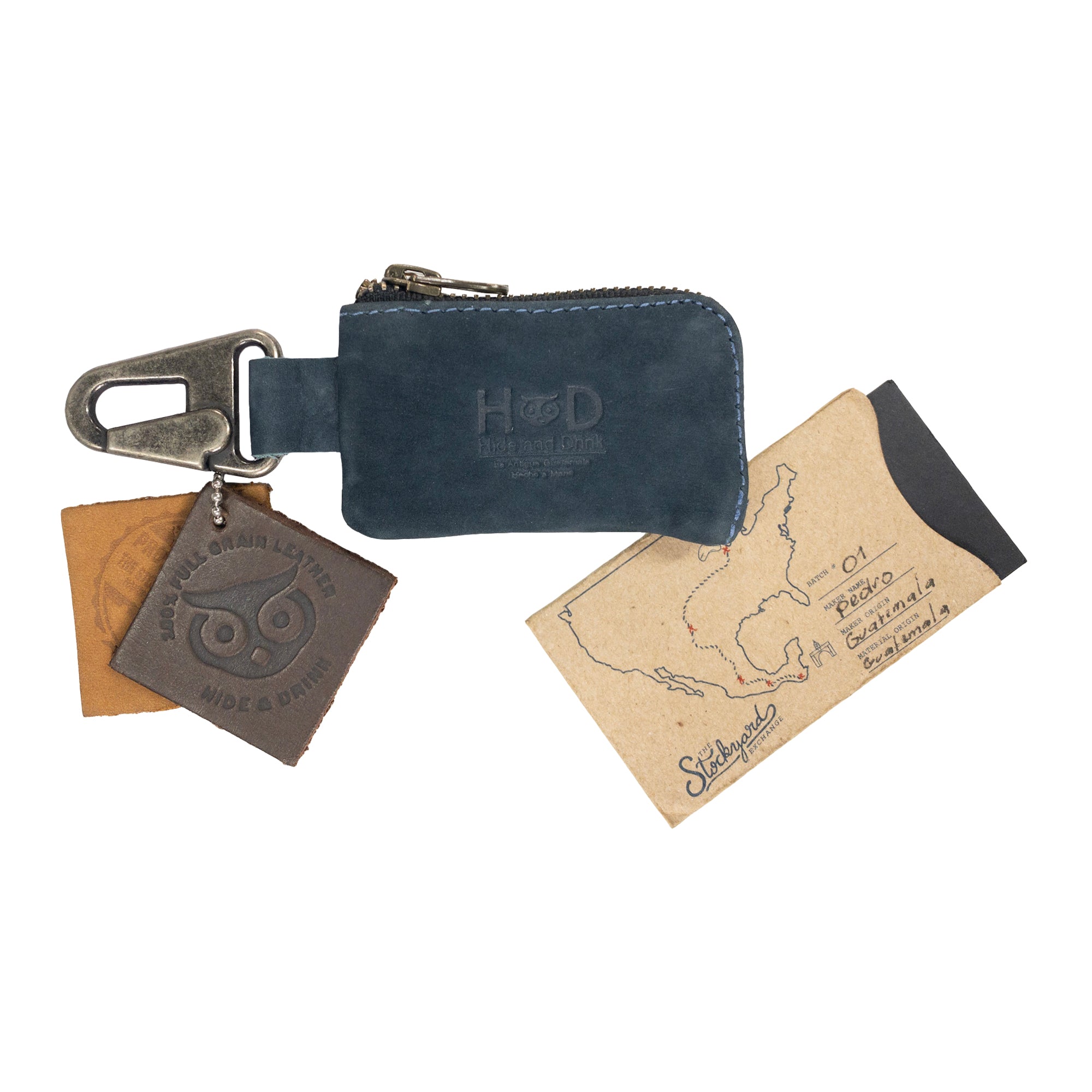 A flat lay image of the Hide & Drink Car Key Holder, displaying its stylish design while featuring cash and keys. Perfect for holding headphone cables, memory cards, and flash drives, this artisan piece is handmade in La Antigua Guatemala & Oaxaca Mexico.