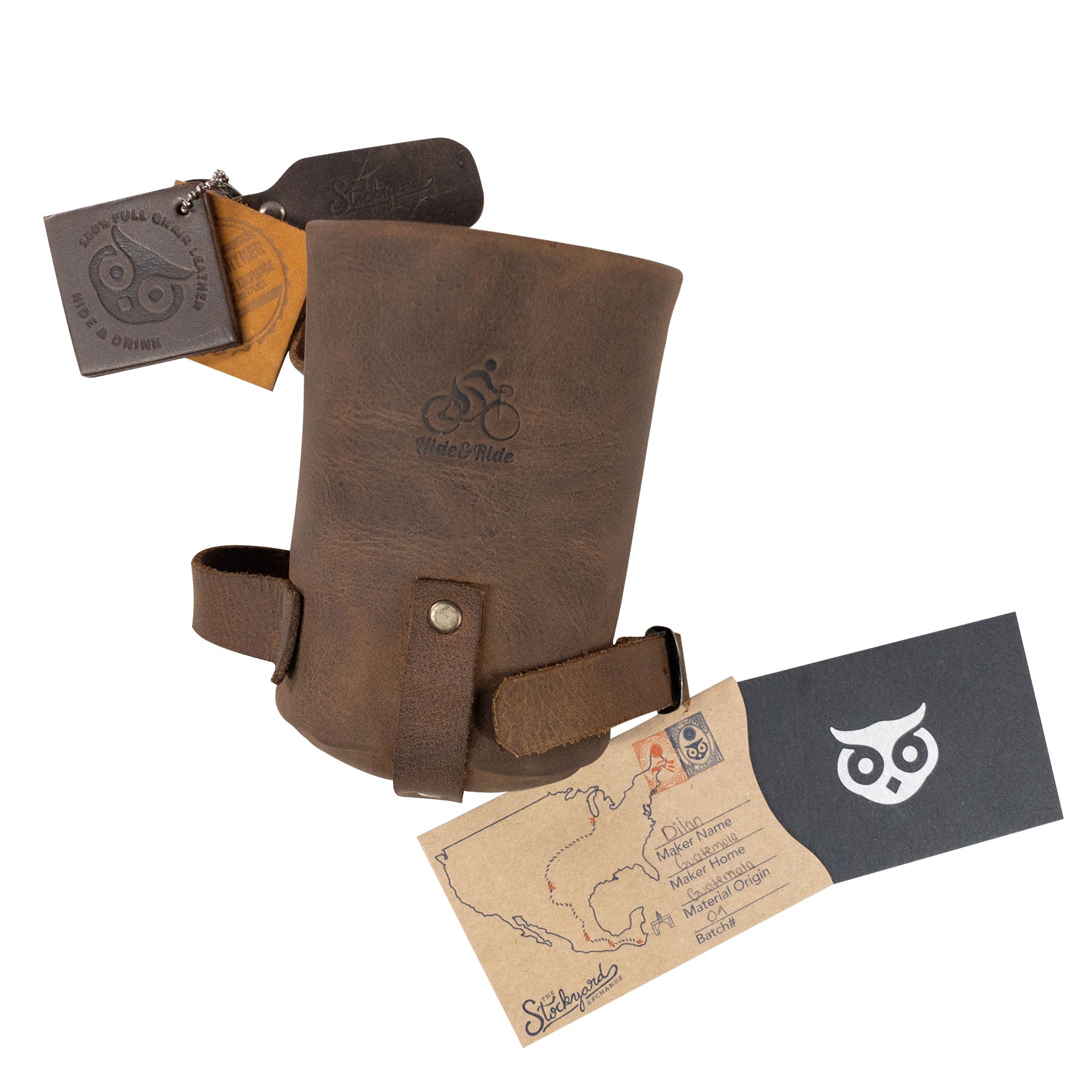 Packaging of the Cruzy Bike Handlebar Cup Holder by Hide & Ride, featuring additional materials and tags. This handcrafted full grain leather item serves as an exceptional insulated beverage pouch for commuters and minimalist bikers, made in La Antigua Guatemala.