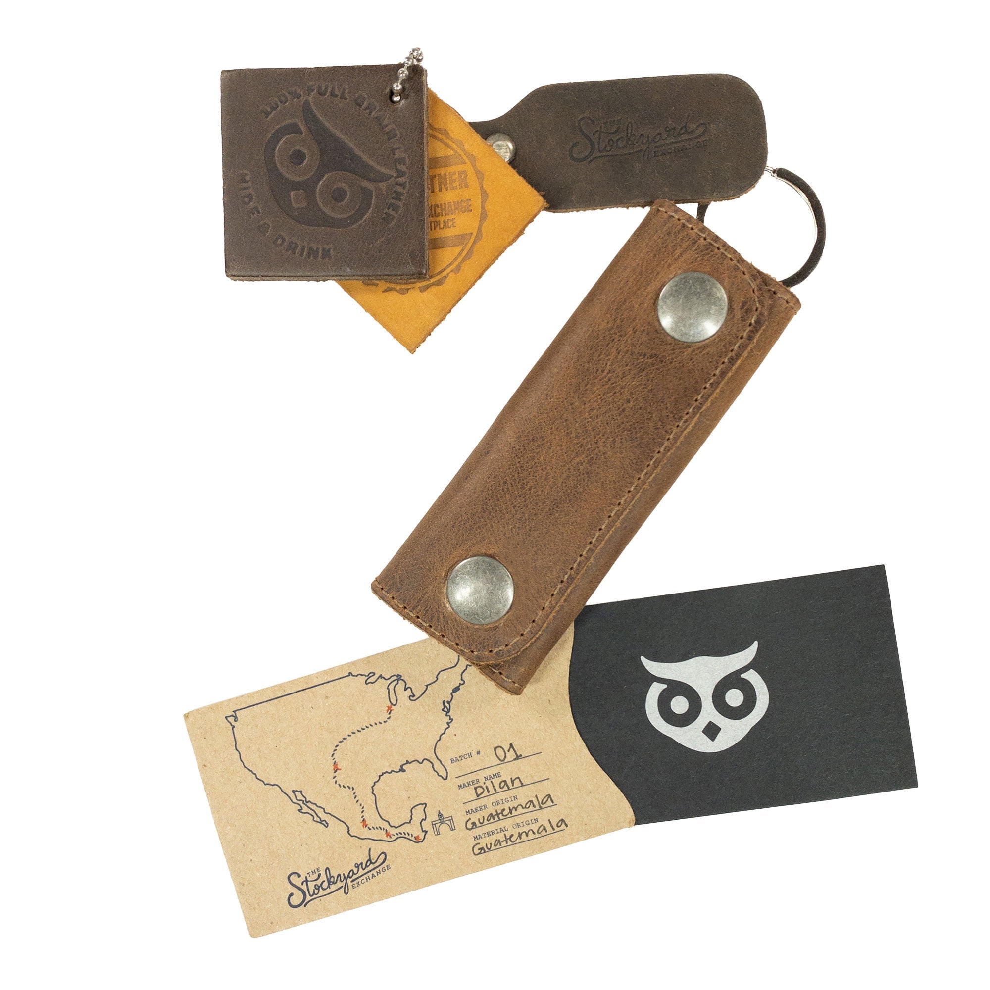The Double Snap Key Holder from Hide & Drink displayed with branded tags depicting its origins and craftsmanship. This handmade accessory in Full Grain Leather showcases the quality and care involved in small batch production by artisans in La Antigua Guatemala & Oaxaca Mexico.