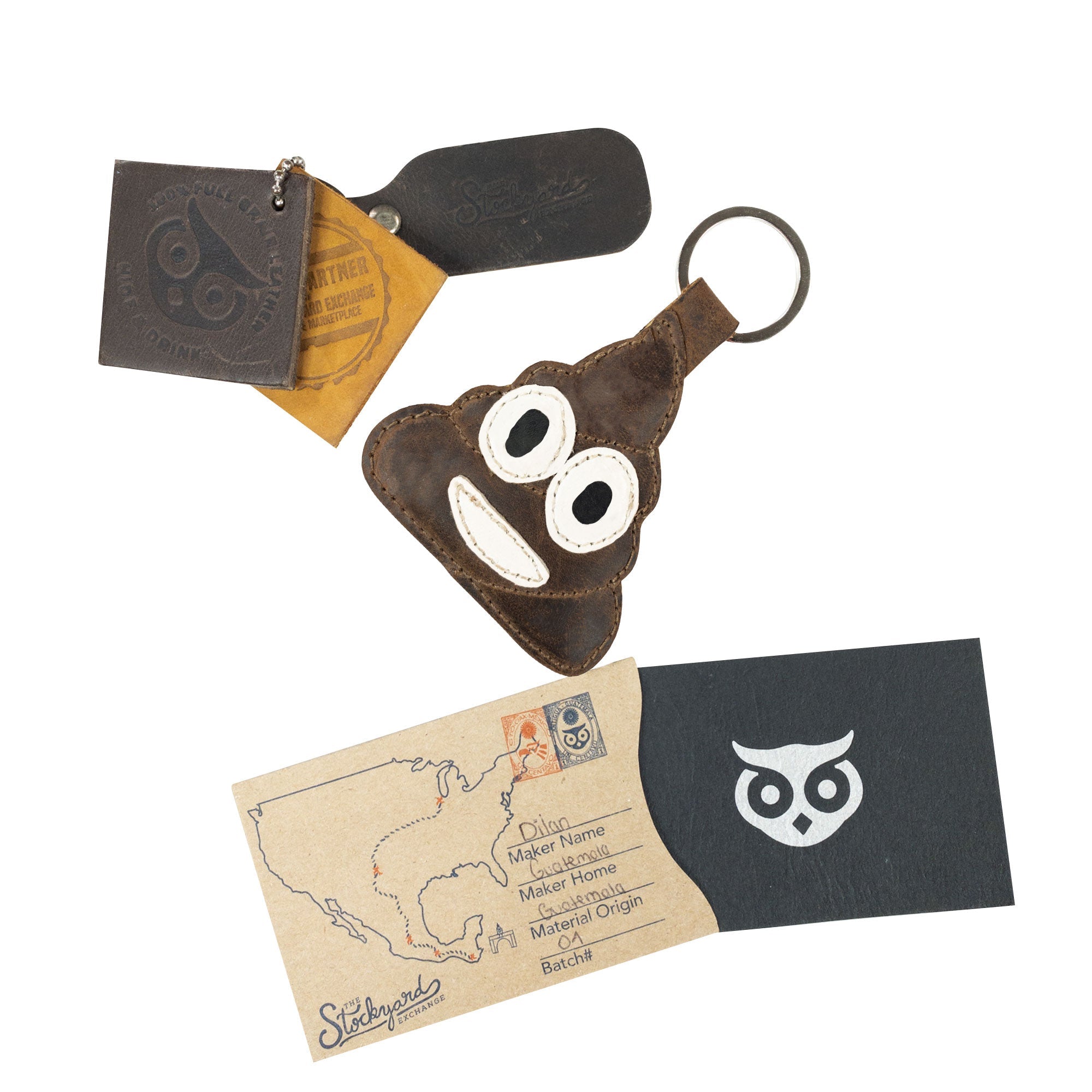 The Poop Emoji Keychain from Hide & Drink alongside identifying materials and paperwork, highlighting its artisan quality. This playful key ring is a fantastic gift option and an enjoyable accessory. Made from Full Grain Leather, it showcases StockyardX’s commitment to Small Batch Production with quality hand-cut and hand-sewn construction. Handmade and fire branded, featuring craftsmanship from La Antigua Guatemala & Oaxaca Mexico.