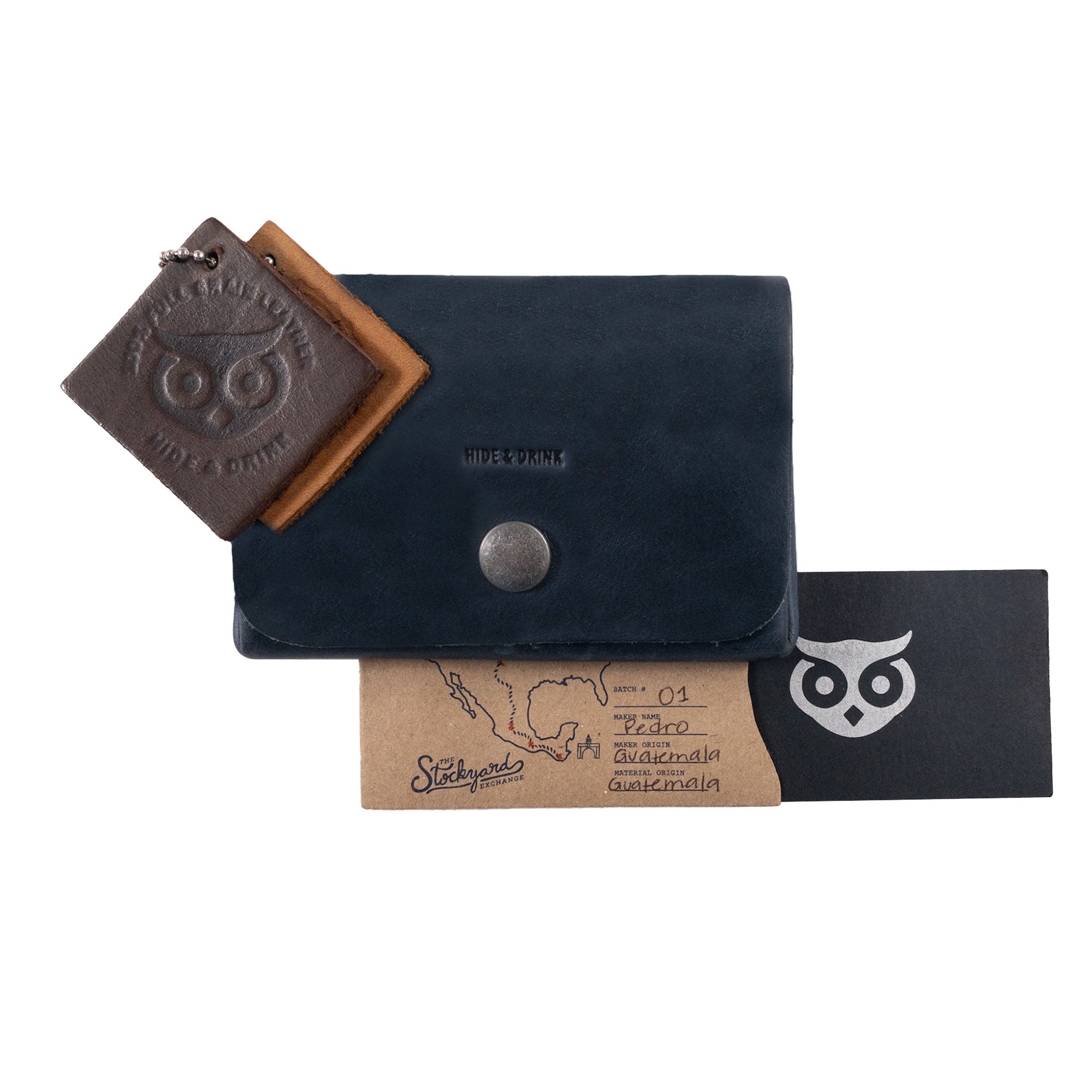 Image showing the gray Double Pouch Card Wallet by Hide & Drink alongside additional leather goods. This versatile Leather Double Pouch Card Wallet functions as a card organizer, cash holder, and ID case, suitable for both men and women, made from Full Grain Leather in La Antigua Guatemala & Oaxaca Mexico.