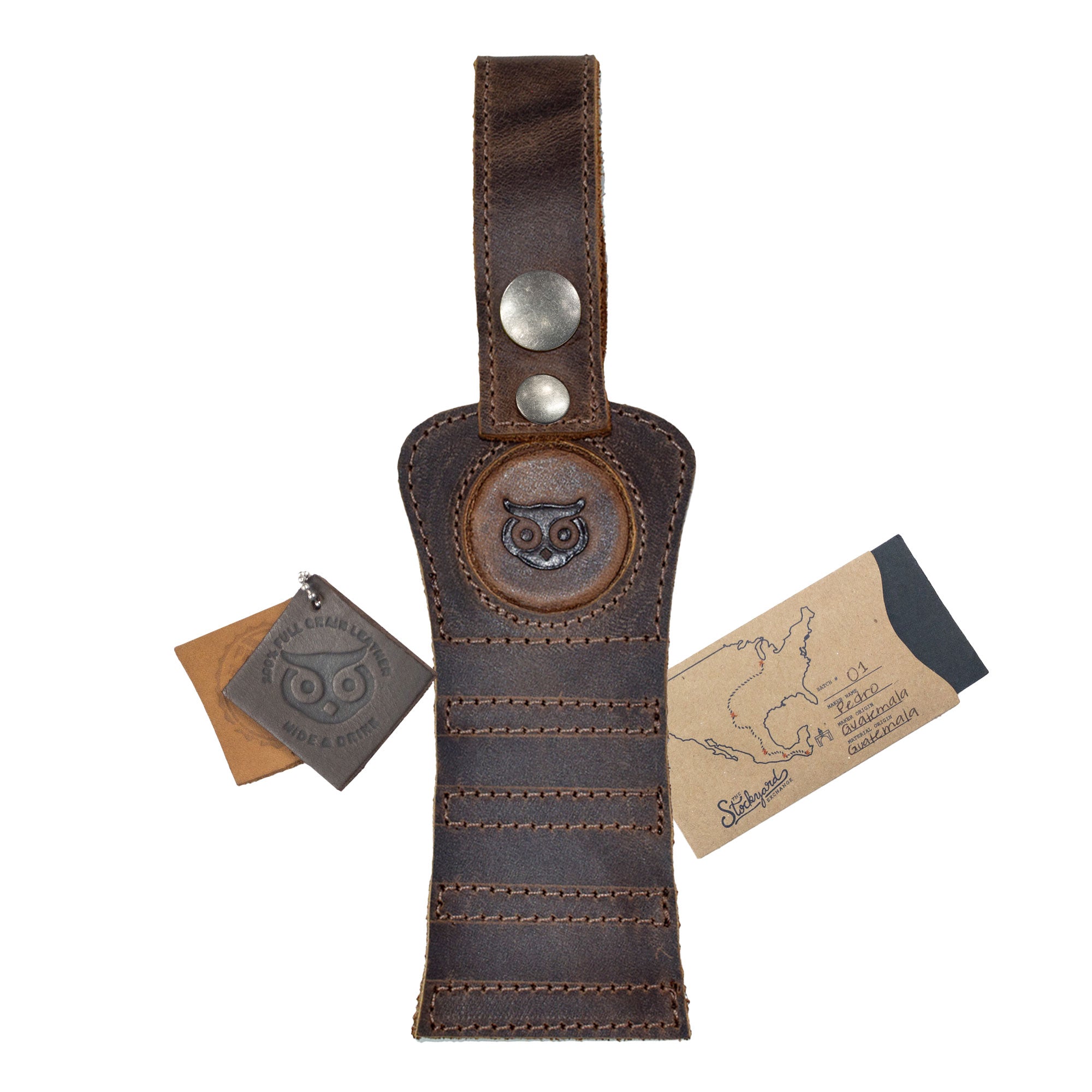 Hide & Drink Golf Tee Holder accompanied by a branded tag, highlighting its artisan quality. This full grain leather holder is perfect for golfers looking to keep their tees handy, with a sturdy hook for attachment to belts or bags, crafted with care in La Antigua Guatemala.