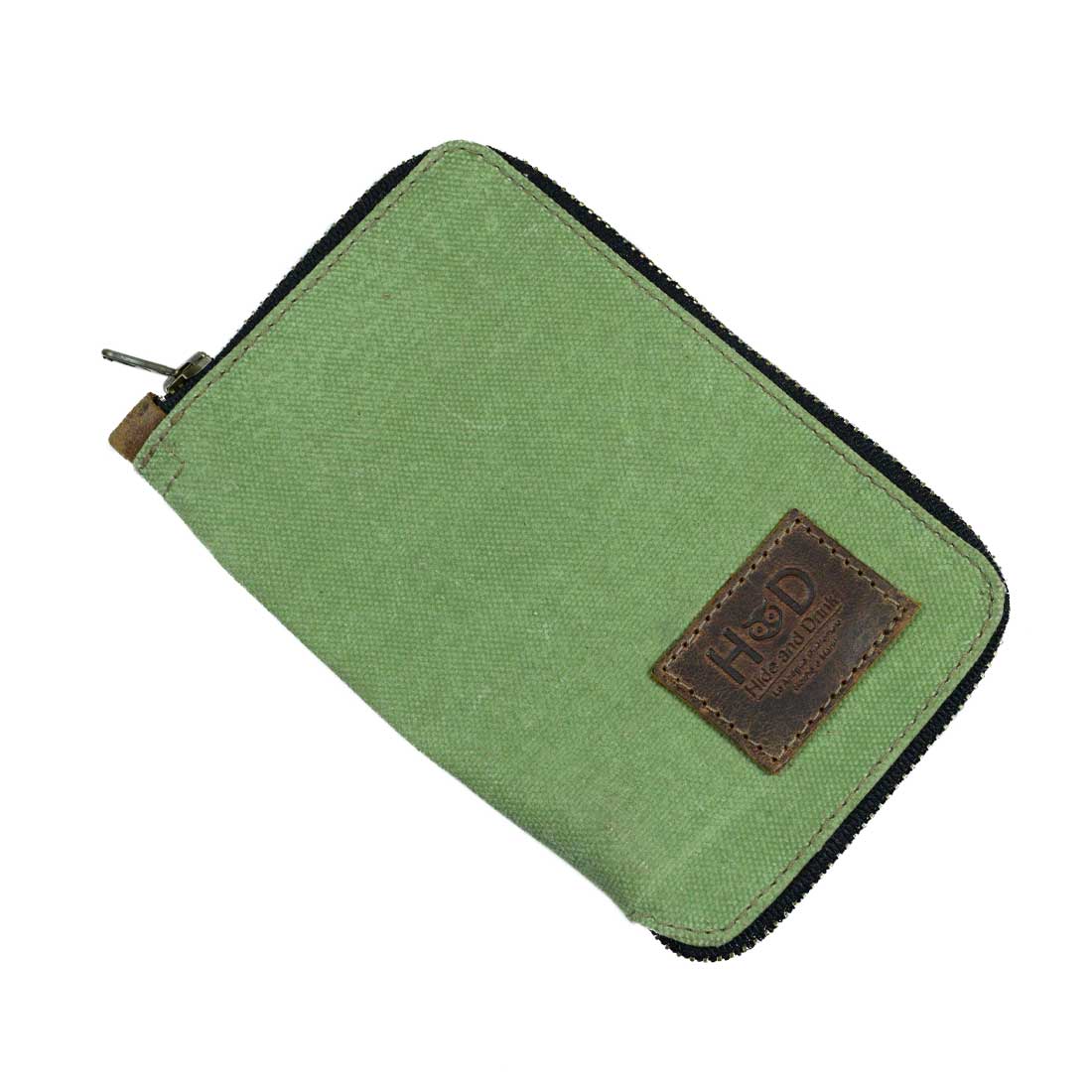 The exterior view of the Waxed Canvas Zippered Journal Cover for Moleskine (Notebook NOT Included) by Hide & Drink, highlighting its green Waxed Canvas finish. An excellent Cahier Case option made with Full Grain Leather in La Antigua Guatemala & Oaxaca Mexico.