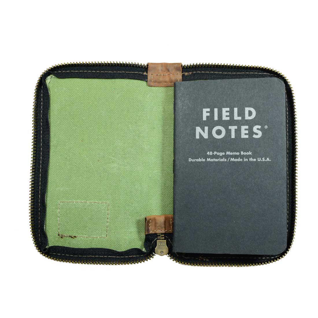 Inside view of the Waxed Canvas Zippered Journal Cover for Moleskine (Notebook NOT Included) by Hide & Drink, showcasing lined pages ready for writing. Great for Cahier Cases, handmade with Full Grain Leather in La Antigua Guatemala & Oaxaca Mexico.