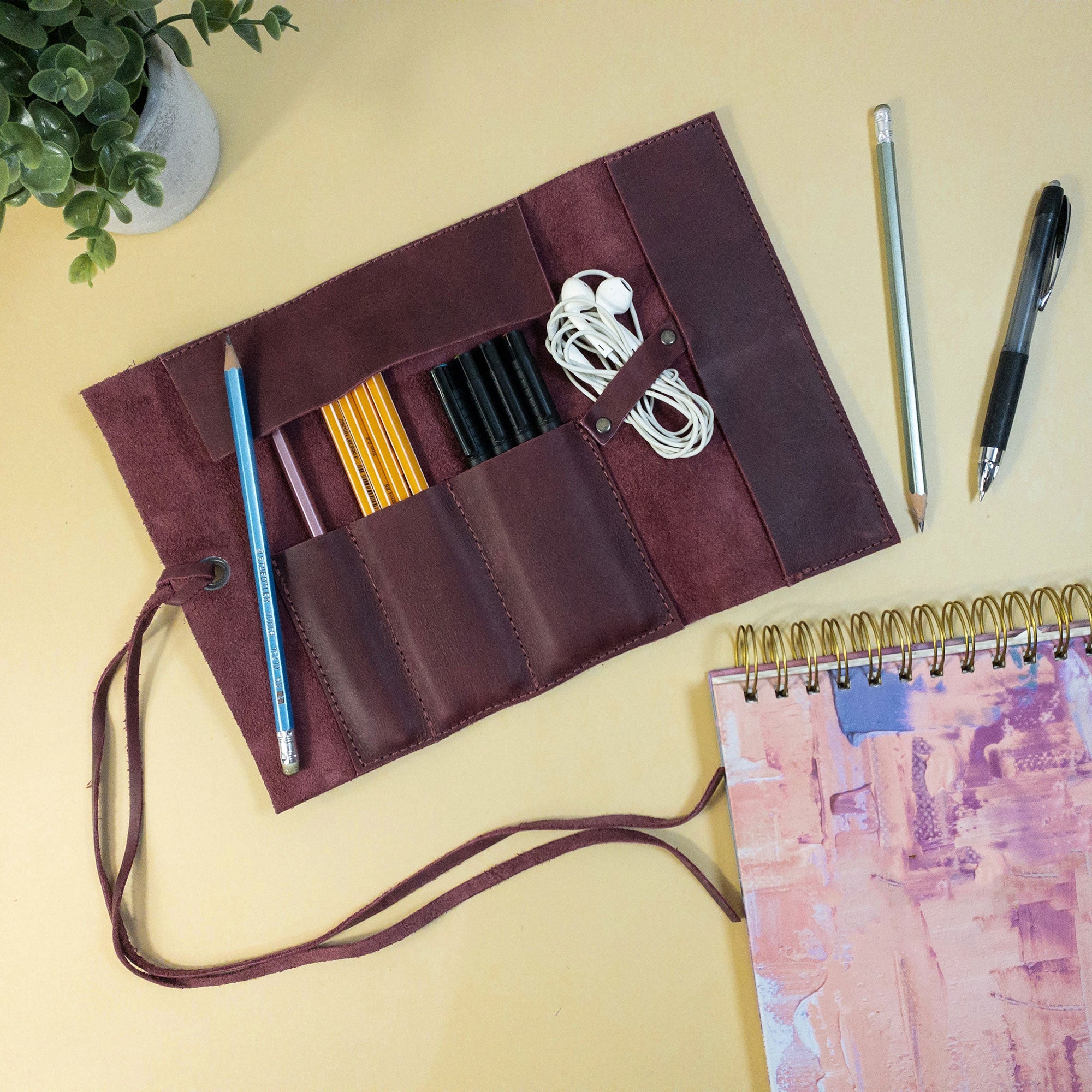 Hide & Drink Multi Purpose Pencil Roll emphasizing the reliable storage features, made for organizing both craft and work tools. Crafted from full grain leather, this rustic pouch is a blend of elegance and functionality.