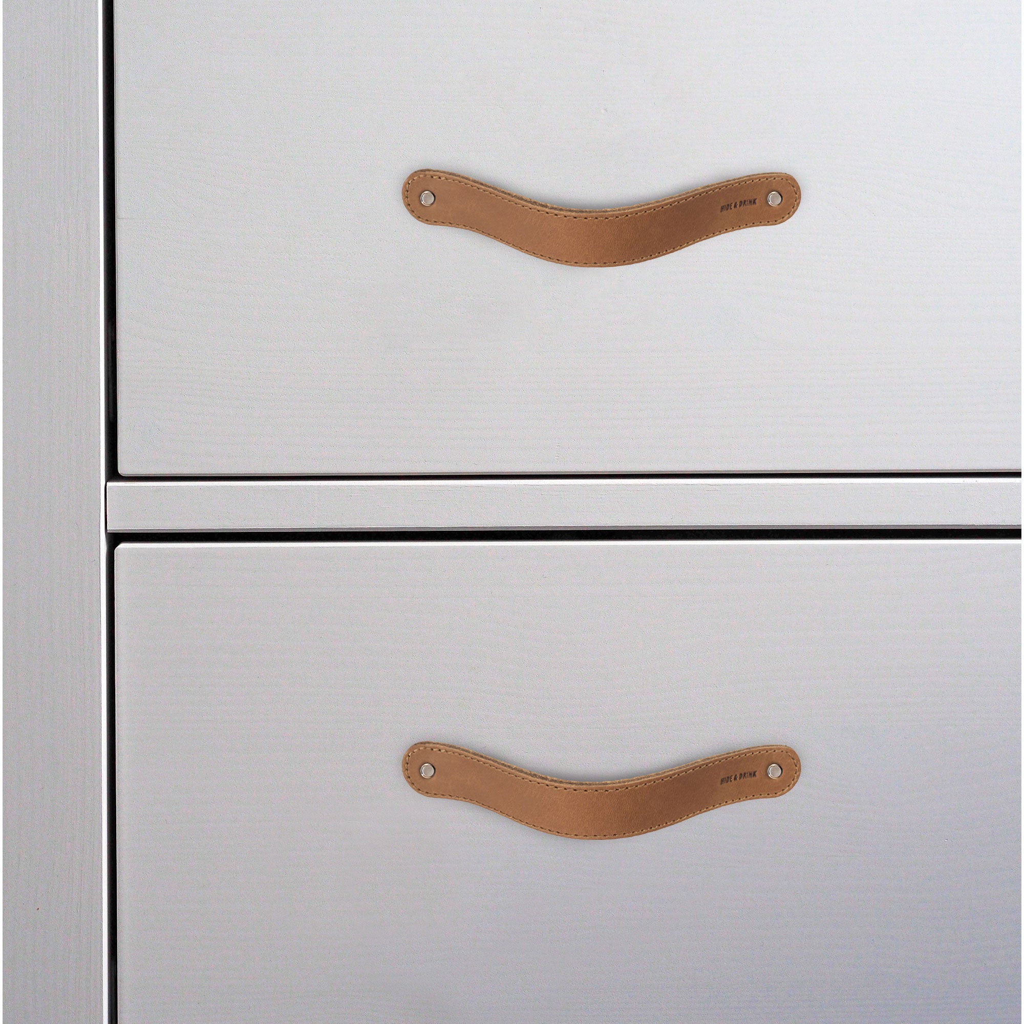 Hide & Drink Drawer Handles (4pk) featuring four beautifully crafted leather handles, ideal for various home projects. Durable and easy to install, each piece reflects artisan craftsmanship.