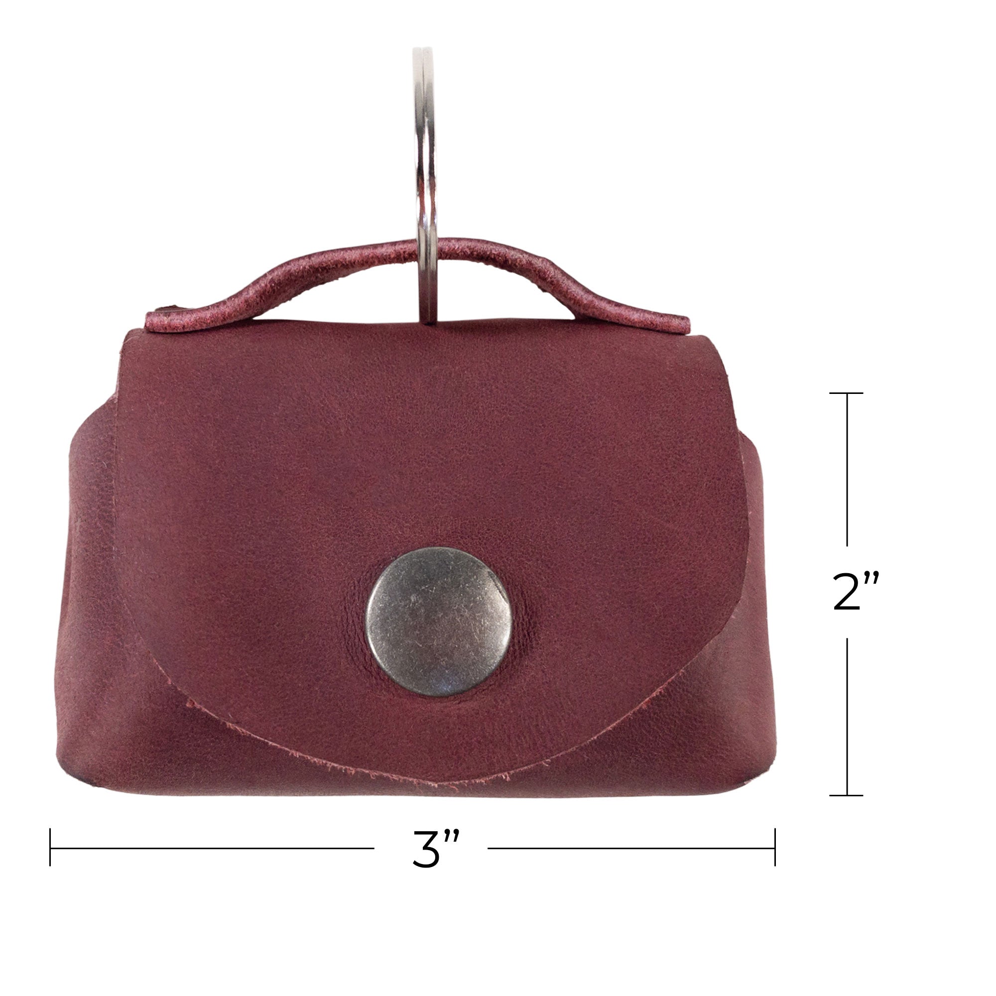 Dimensions of the Tiny Handbag Keychain by Hide & Drink displayed alongside a ruler, measuring 3 inches by 2 inches. This artisan-crafted keychain features a robust Full Grain Leather design and represents small batch production techniques.
