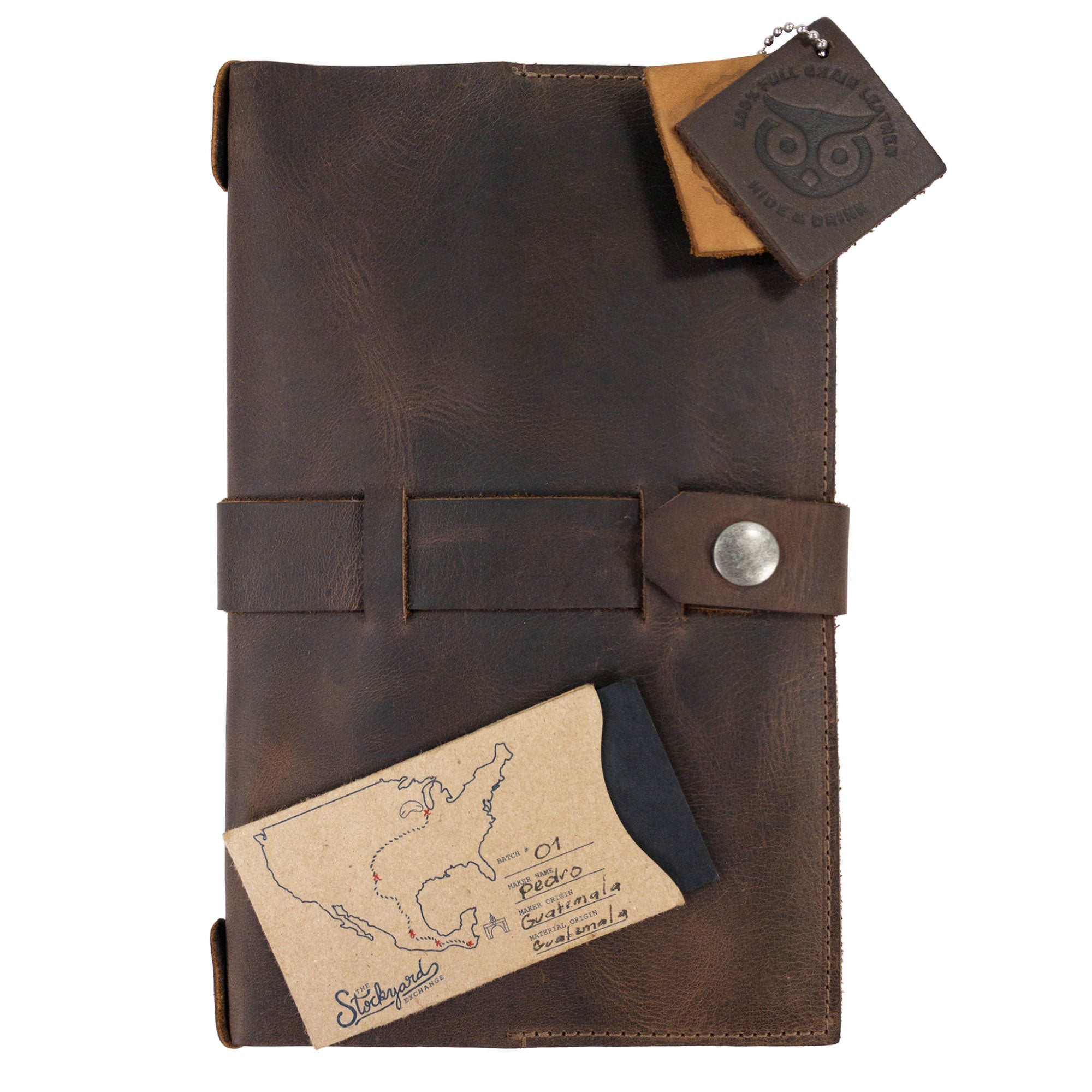 Hide & Drink's Riveted Field Note Cover for Moleskine (5 x 8.25 in.) Notebook NOT Included elegantly displayed with accessories. This stylish, full grain leather cover is handcrafted, emphasizing artisan skill and small batch production in La Antigua Guatemala & Oaxaca, Mexico.