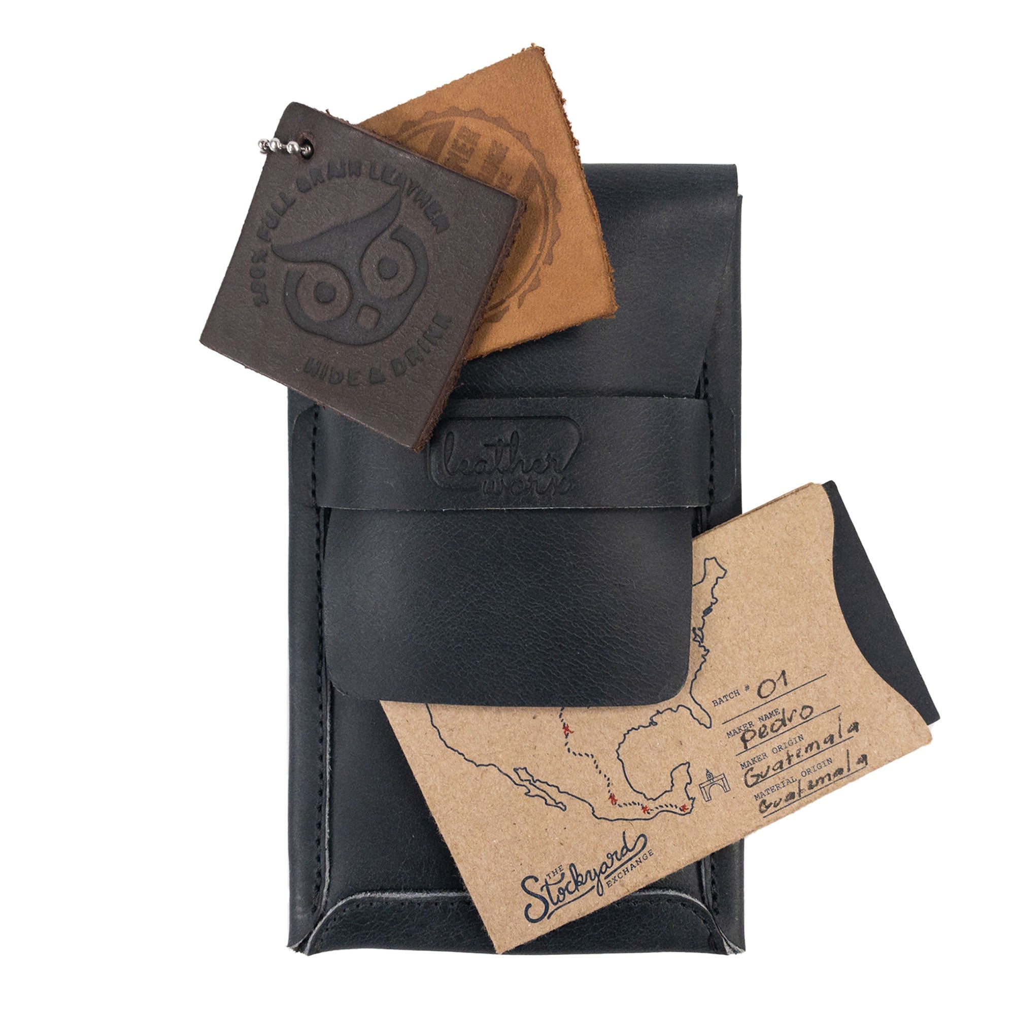 The Leather Worx Double Pen Case alongside tags and cards, showcasing the artisanal quality of Full Grain Leather. Hand cut and hand sewn, this product embodies small batch production principles and is fire branded, made in La Antigua Guatemala.