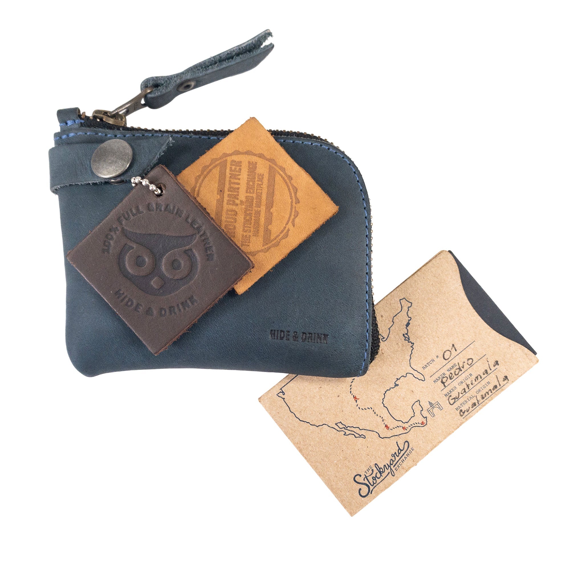 Lion's Mane Zippered Wallet by Hide & Drink, featuring a card and a paper tag showcasing its handmade origin. A stylish piece that makes for a perfect gift or travel essential.