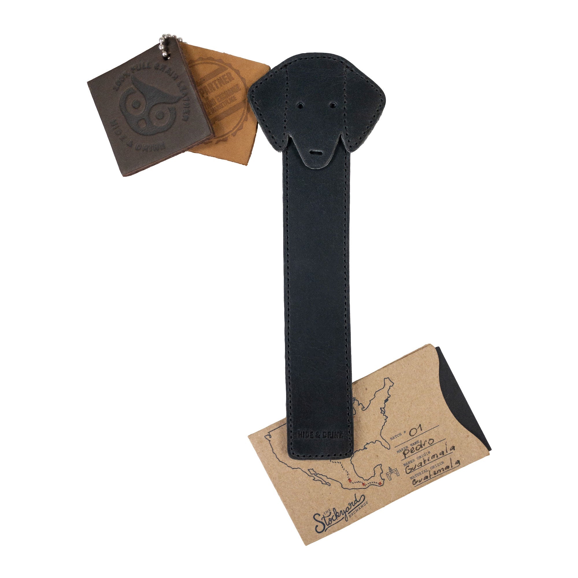 Hide & Drink's black Dog Bookmark with packaging, showcasing its quality Full Grain Leather design. This artisan bookmark features elements of small batch production and fire branding, handmade in La Antigua Guatemala & Oaxaca Mexico.