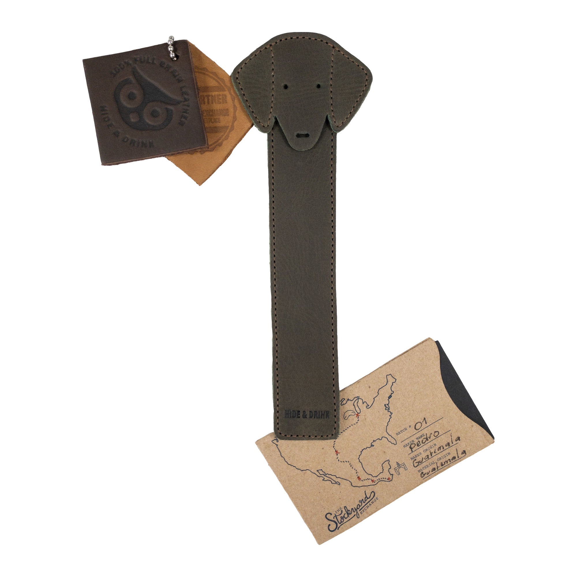 Hide & Drink's brown Dog Bookmark presented with packaging, illustrating its Full Grain Leather make. This artisan bookmark celebrates small batch production and fire branding, made in La Antigua Guatemala & Oaxaca Mexico.