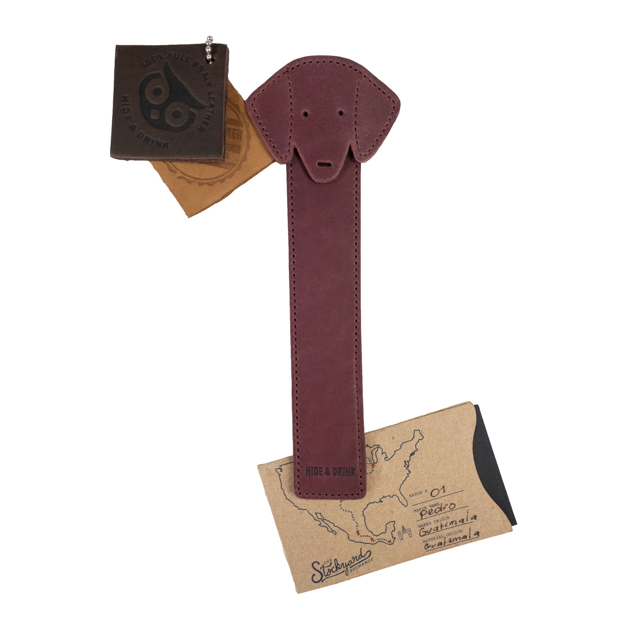 Hide & Drink's burgundy Dog Bookmark with packaging, showcasing its quality Full Grain Leather design. This artisan bookmark highlights elements of small batch production and fire branding, proudly made in La Antigua Guatemala & Oaxaca Mexico.
