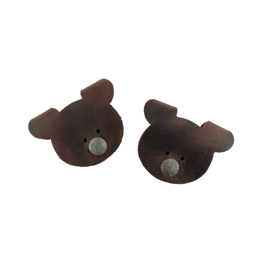A pair of darker Bear Shaped Cord Keepers (Cord Clam) by Hide & Drink, made with Full Grain Leather, emphasizing the artisanal quality and handmade nature from La Antigua Guatemala & Oaxaca Mexico. Small Batch Production.