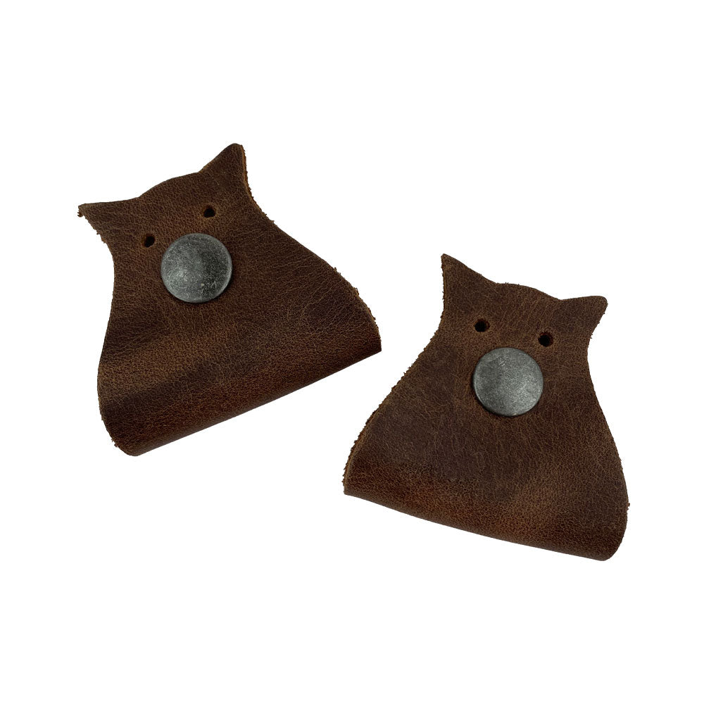 Owl Shaped Cord Keeper (2-Pack) by Hide & Drink showcasing a rich brown leather design that adds a stylish touch to cable management. Owl Shaped Cord Keeper (Cord Clam) 2-Pack. Full Grain Leather, StockyardX, Small Batch Production, Hand Cut, Hand Sewn, Fire Branded, Artisan, Handmade in La Antigua Guatemala & Oaxaca Mexico.