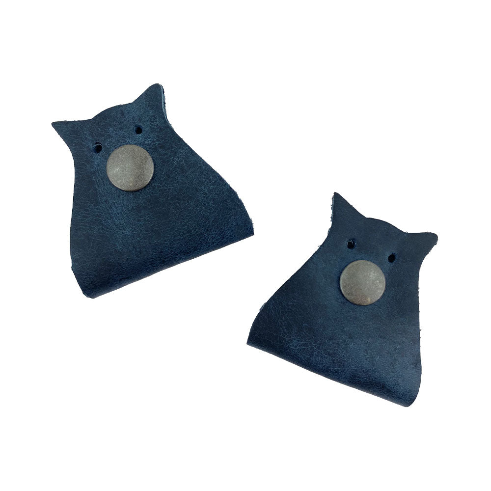 Owl Shaped Cord Keeper (2-Pack) by Hide & Drink presented in a sleek dark blue leather, ideal for classy cable management. Owl Shaped Cord Keeper (Cord Clam) 2-Pack. Full Grain Leather, StockyardX, Small Batch Production, Hand Cut, Hand Sewn, Fire Branded, Artisan, Handmade in La Antigua Guatemala & Oaxaca Mexico.