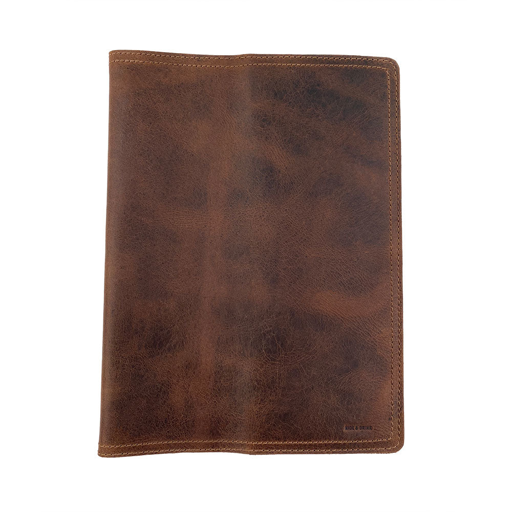 A stylish depiction of the Hard Cover Notebook Protector (Notebook NOT Included) by Hide & Drink, emphasizing its design. This journal cover is meant for Moleskine Hard Cover Sketchbook XXL Size (8.5 x 11 in.), Notebook NOT Included, crafted with rich Full Grain Leather. It embodies StockyardX’s small batch production with hand cut, hand sewn, and fire branded artistry, all handmade in La Antigua Guatemala & Oaxaca Mexico.