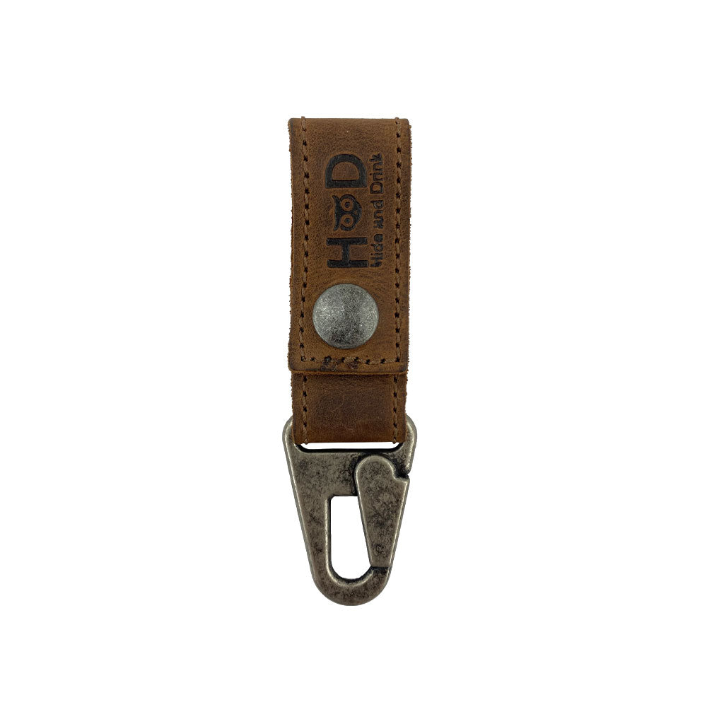 Close-up of the Hide & Drink Key Ring Holder crafted from durable Full Grain Leather, showcasing its robust clip design. This handmade Key Ring Holder exemplifies Small Batch Production, Artisan attention to detail, and Hand Cut, Hand Sewn techniques in La Antigua Guatemala & Oaxaca Mexico.