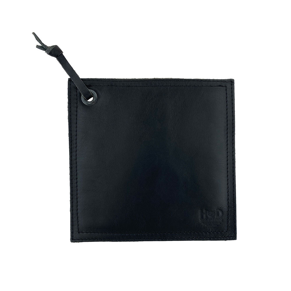 Rustic brown Hide & Drink Pot Pad displayed with fine craftsmanship and a durable design. This artisan pot pad is made from full grain leather for effective heat resistance.