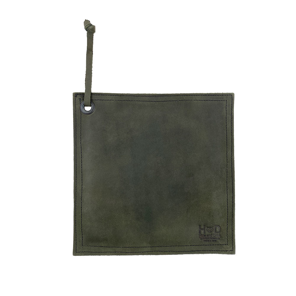 Hide & Drink Pot Pad in deep blue leather, showcasing its artisan craftsmanship. Perfect for protecting surfaces from hot items, it combines practicality with style.