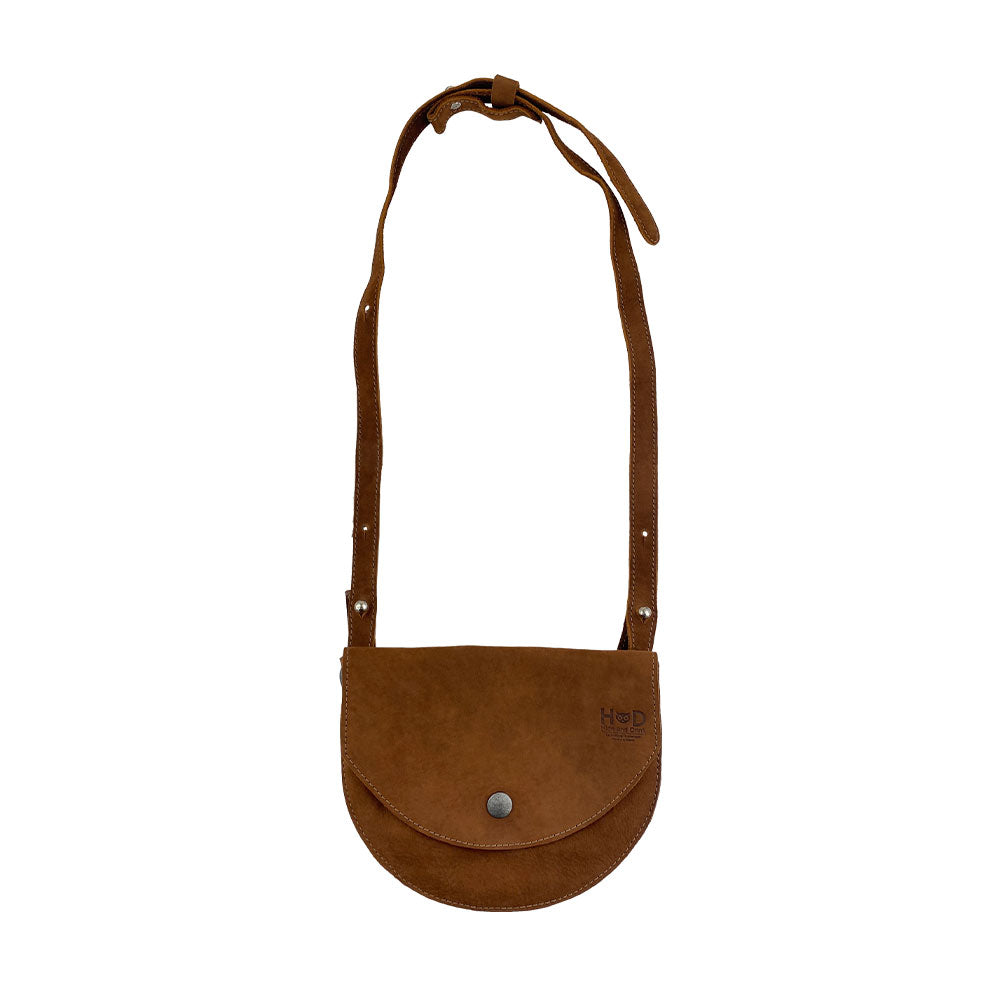 Front view of a tan version of the Hip and Shoulder Bag by Hide & Drink, crafted from Full Grain Leather for a stylish look. This handcrafted piece emphasizes Small Batch Production with its hand cut and hand sewn features. Handmade in La Antigua Guatemala & Oaxaca Mexico.