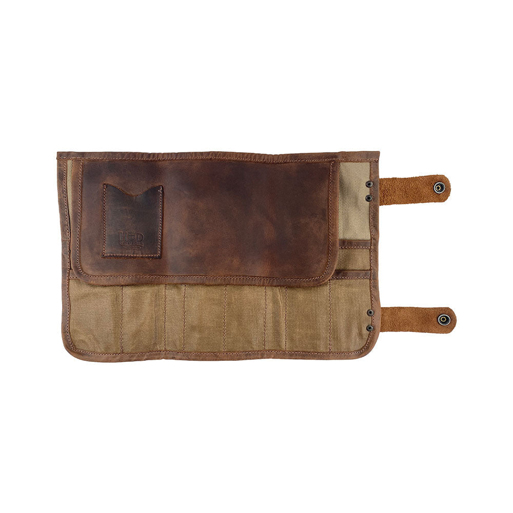 Hide & Drink's Barber Tool Roll, featuring a Snap Tool Roll Up Bag with 14 Slots, perfect for organized storage of scissors & screwdrivers. Constructed from high-quality Full Grain Leather, this portable carry case highlights StockyardX's ethos of small batch production and artisan craftsmanship, hand cut, hand sewn, and fire branded in La Antigua Guatemala & Oaxaca Mexico.