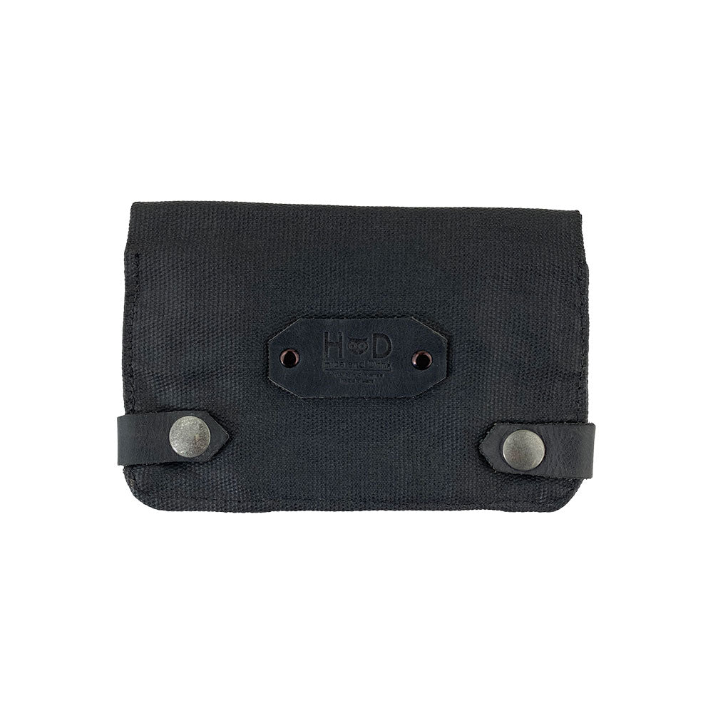 Front view of the black Hide & Drink Tobacco Pouch Waxed Canvas. This durable tobacco pouch and field notes case embodies artisan craftsmanship and modern design, perfect for travel and storage needs.