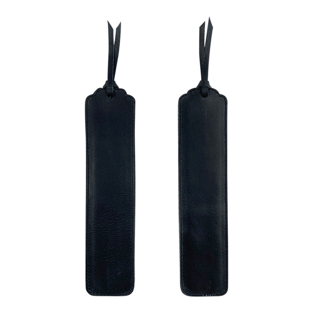 Deluxe Long Bookmark (2 Pack) by Hide & Drink, showcasing a set of two black leather bookmarks. These stylish reversible page markers serve as classic accessories for reading lovers, crafted from full grain leather, highlighting stockyardX, small batch production, hand cut, hand sewn, fire branded, artisan details, handmade in La Antigua Guatemala & Oaxaca Mexico.