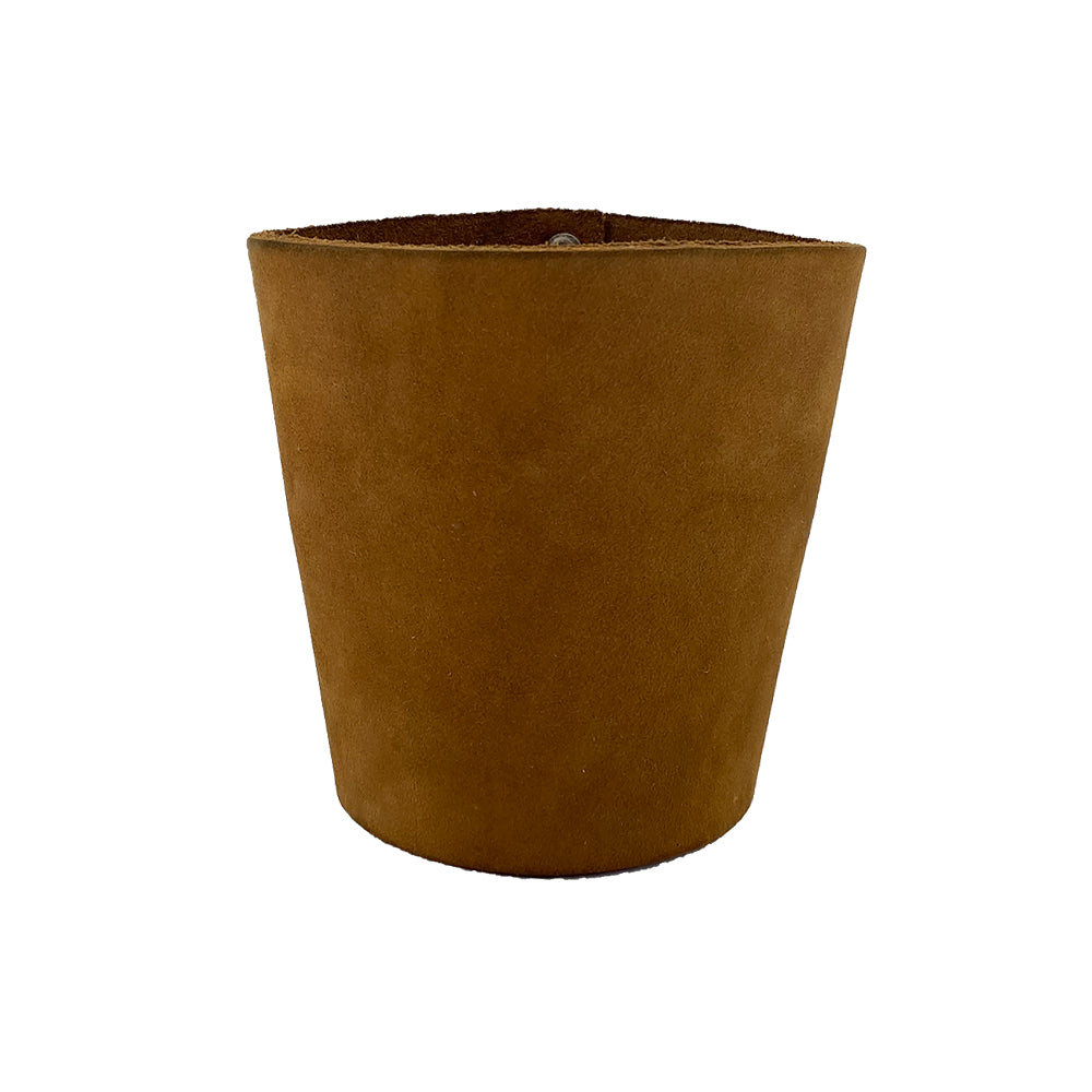 A brown leather Pint Sleeve by Hide & Drink showcasing a smooth texture and sturdy finish. This artisan piece offers natural temperature control and is perfect for gifts, featuring brass metal rivets and handmade in La Antigua Guatemala & Oaxaca Mexico.