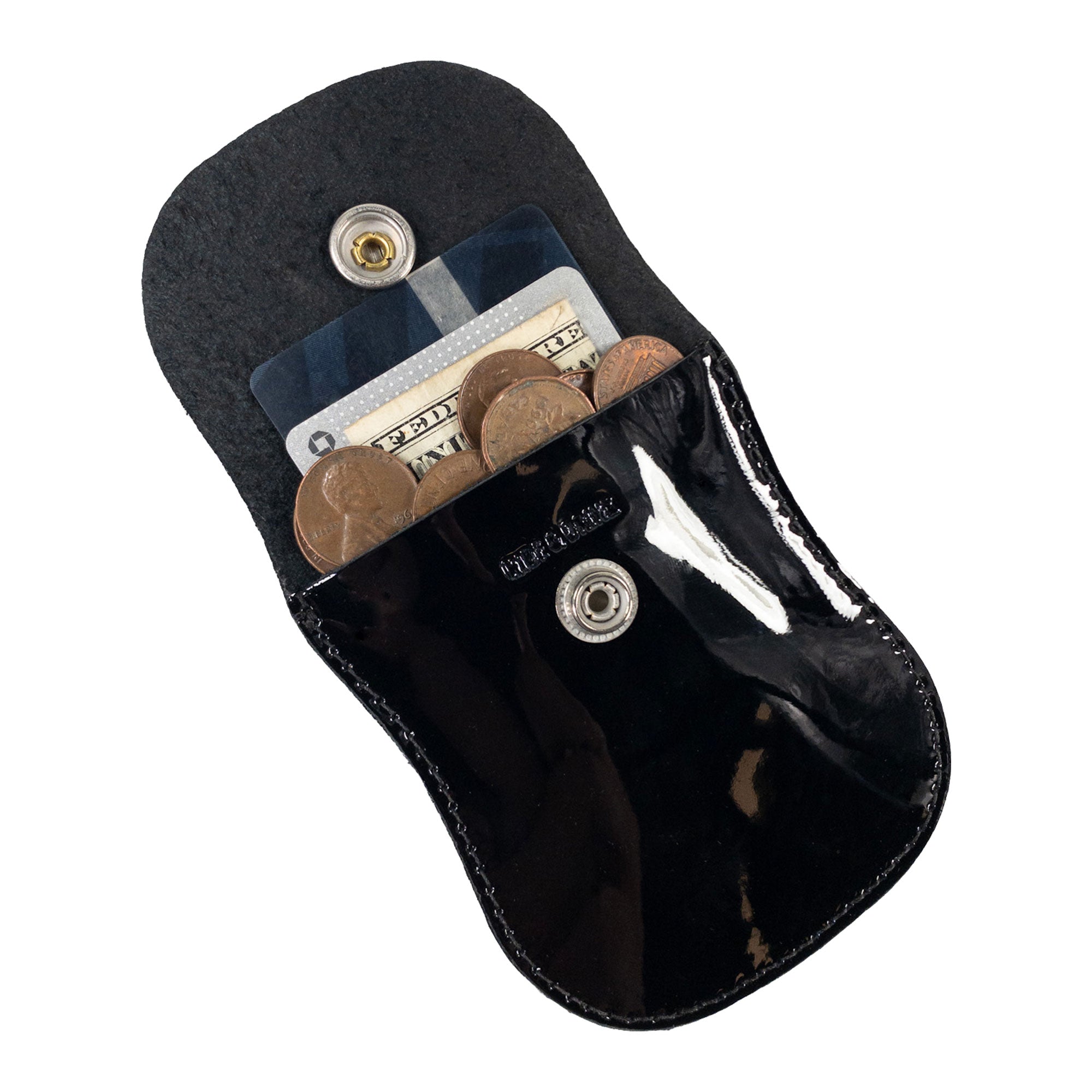 The Curvy Coin Pouch by Hide & Drink, open and filled with coins and a bill, highlighting its practical design in full grain leather as a small batch artisan product.