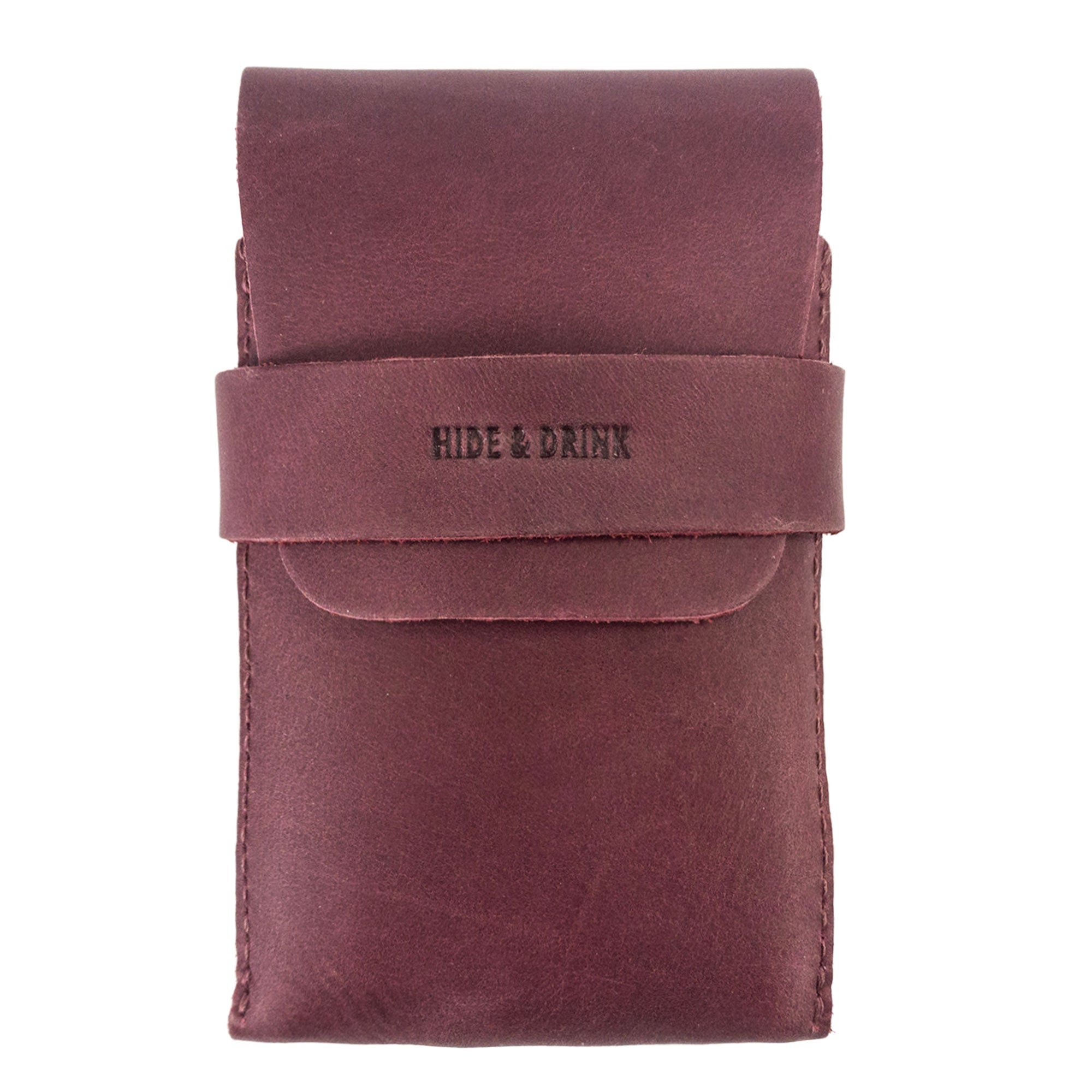 Front view of Hide & Drink's burgundy Playing Card Case. This stylish accessory is designed for secure storage of classic playing cards (not included). Made from premium full grain leather, this artisan-crafted piece from StockyardX is handmade in La Antigua Guatemala.