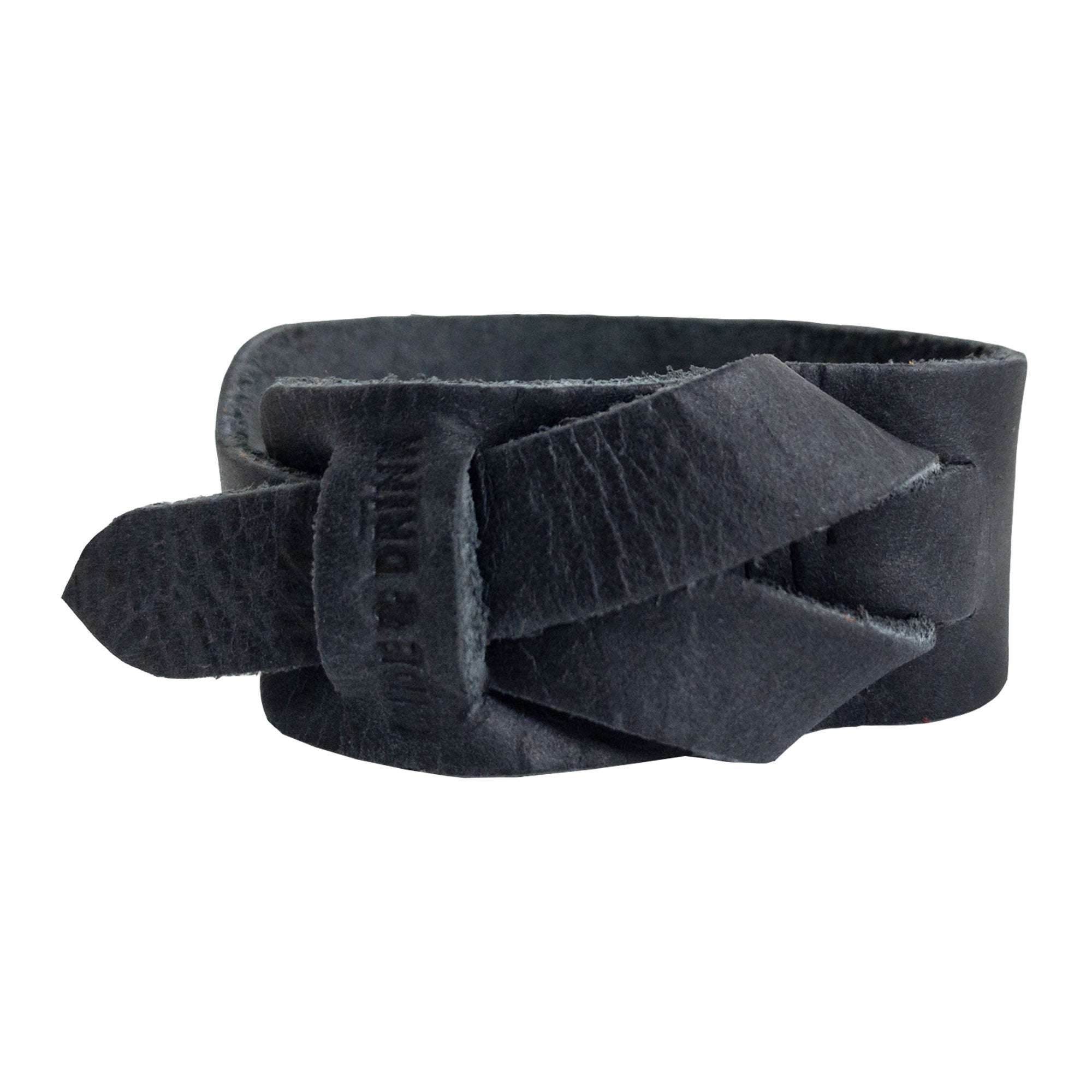 Hide & Drink's Minimalist Wristband captured in a sleek black full grain leather variation. This stylish cuff features a unique texture and adjustable strap, handcrafted by artisans in La Antigua Guatemala. An elegant bracelet by StockyardX representing small batch production and artisan quality.