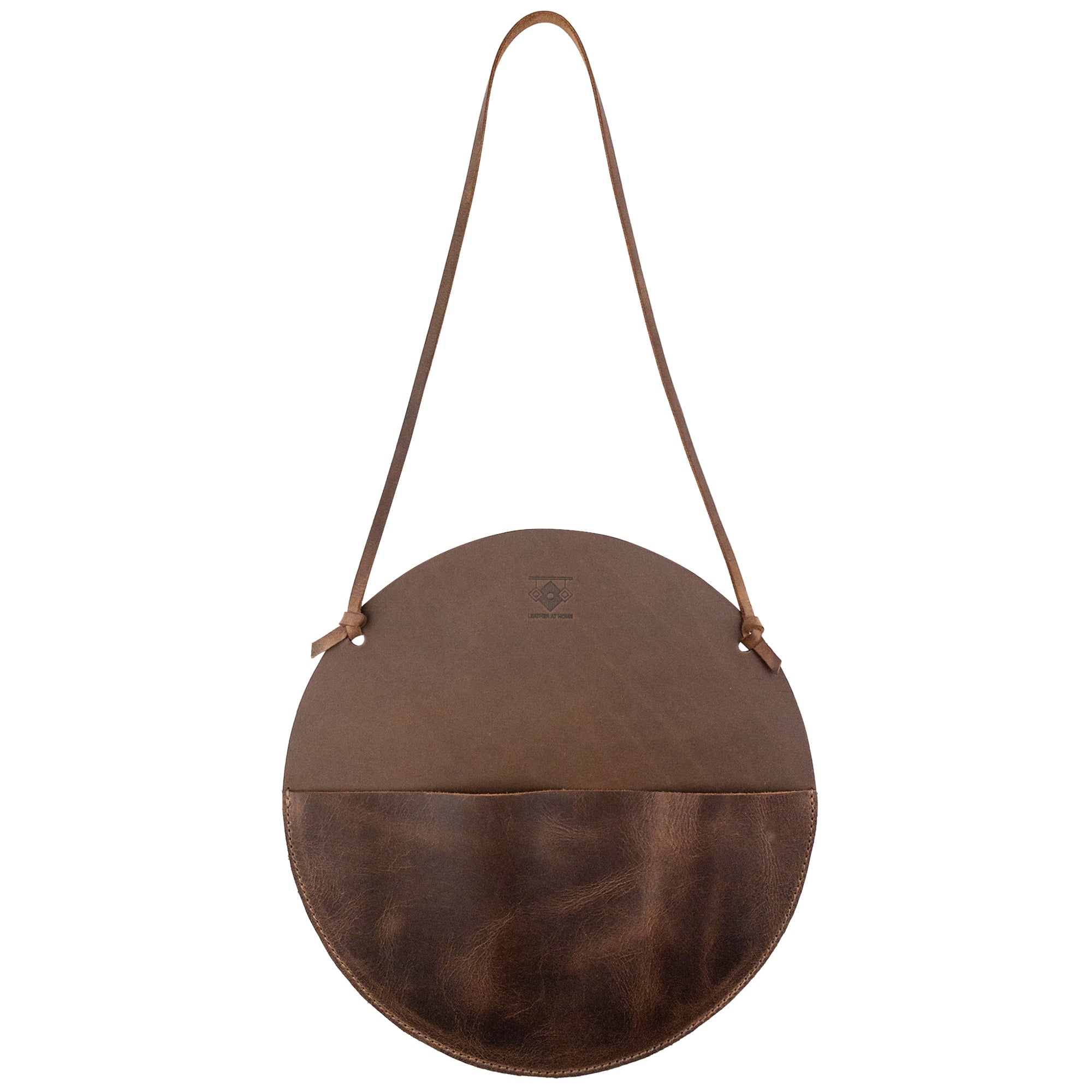 Leather At Home Circular Wall Hanger, a stylish and functional wall file organizer in full grain leather. Perfect for storing documents, letters, invoices, and envelopes. Handmade in La Antigua Guatemala, showcasing artisan craftsmanship with small batch production techniques.