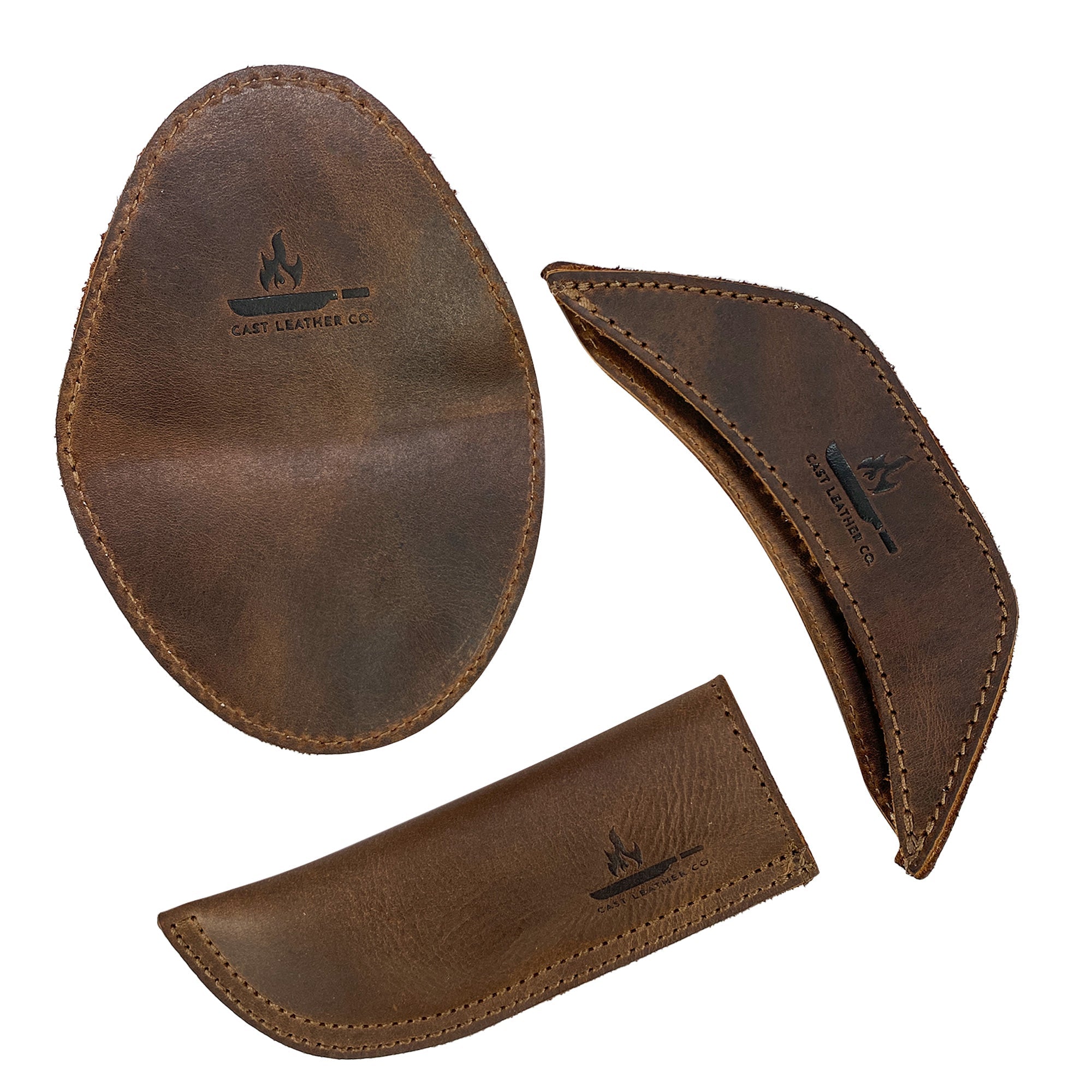 Displaying the components of the Hot Handle Holders Set of 3 by Cast Leather Co., this image captures the panhandle, side kick, and grip mitt made from premium full grain leather. Perfect for those seeking reliable assist grips for cast iron skillets and pans, each leather holder is hand cut, hand sewn, and fire branded, reflecting the artisan craftsmanship available in La Antigua Guatemala & Oaxaca Mexico.