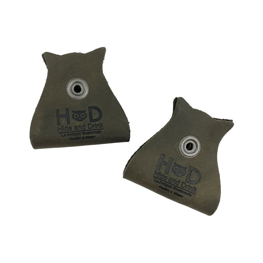 Elegant Owl Shaped Cord Keeper (2-Pack) by Hide & Drink featuring a modern design in dark green leather with a snap closure. Owl Shaped Cord Keeper (Cord Clam) 2-Pack. Full Grain Leather, StockyardX, Small Batch Production, Hand Cut, Hand Sewn, Fire Branded, Artisan, Handmade in La Antigua Guatemala & Oaxaca Mexico.