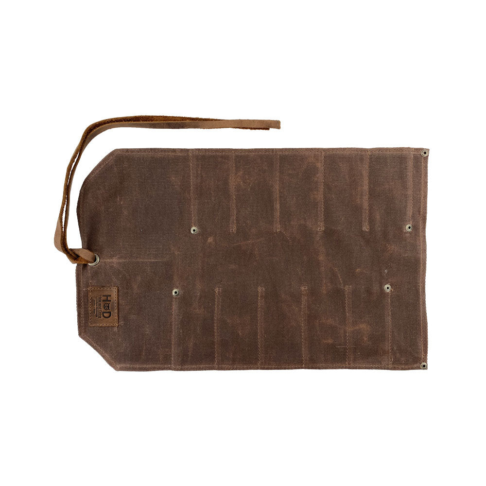 Hide & Drink Tool Roll features a classic small tool roll-up bag with 10 slots, crafted from durable full grain leather. Ideal as a portable carry-on pouch for organizing woodworking tools, enhancing your workshop storage solutions. Each piece is hand cut and sewn with care in La Antigua Guatemala & Oaxaca Mexico.