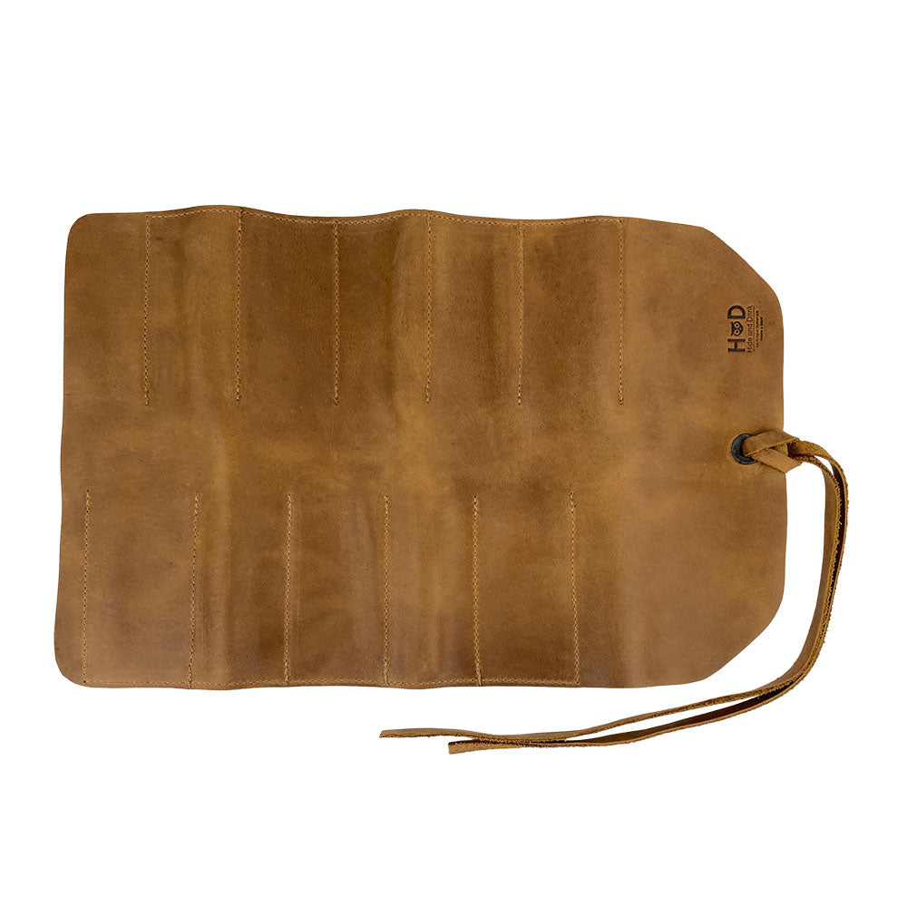 Hide & Drink Tool Roll features an elegant small tool roll-up bag with 10 slots, constructed from premium full grain leather. This portable carry-on pouch excels in organizing woodworking tools and enhancing your workshop storage setup. Handmade by skilled artisans in La Antigua Guatemala & Oaxaca Mexico.