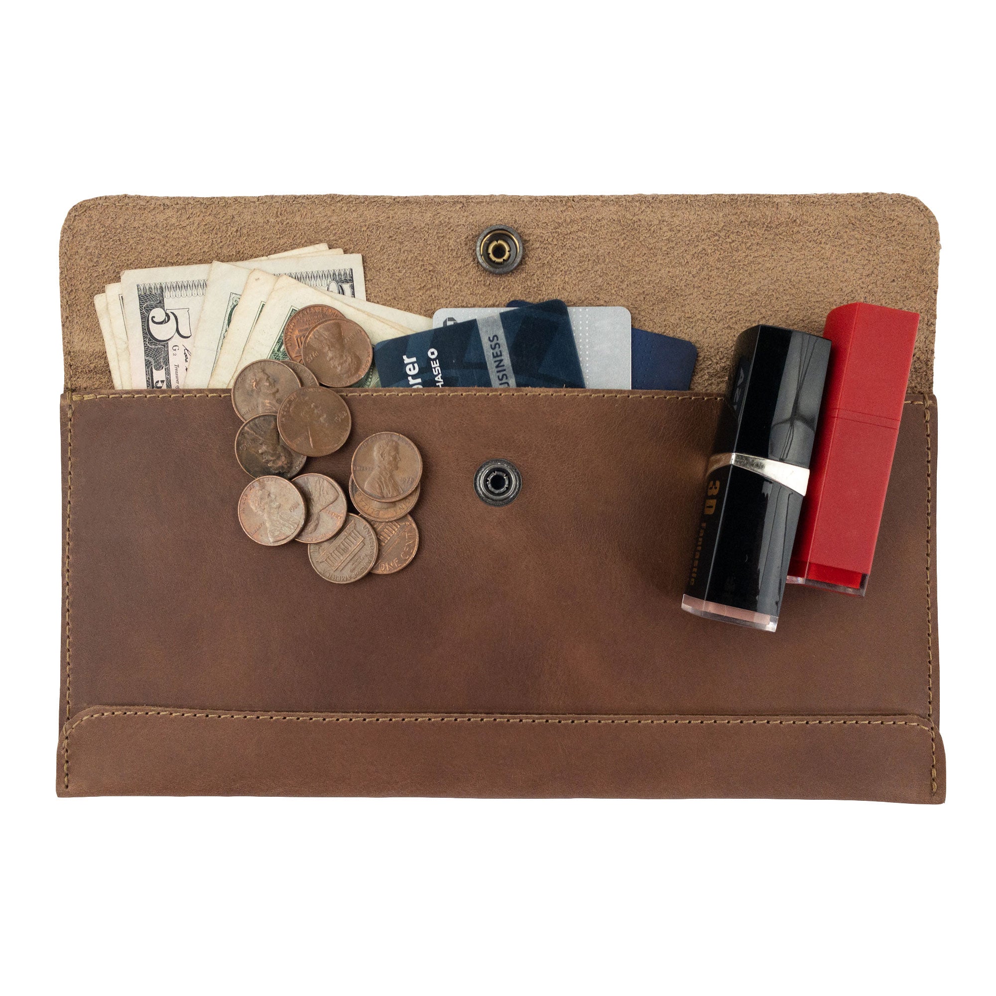 The interior of Hide & Drink's brown Travel Hand Wallet filled with cards and coins, showing its spaciousness and quality craftsmanship in Full Grain Leather. This Travel Wallet is carefully handmade in La Antigua Guatemala & Oaxaca Mexico.