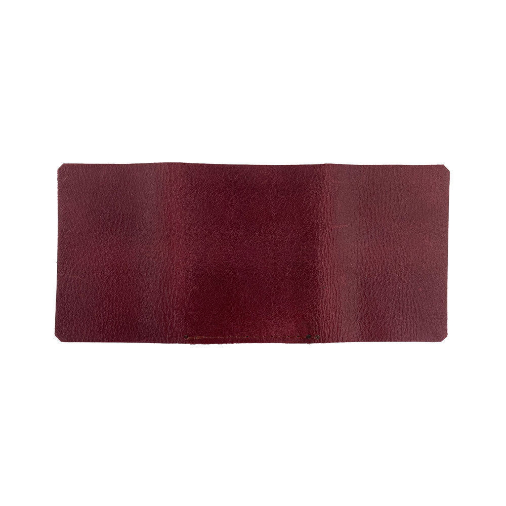 An artistic shot of the Hide & Drink Minimalist Wallet Bills Only, showcasing its design while holding cash. This Ultra Minimalist Wallet serves effectively as a cash organizer, embodying the artisan spirit of small batch produced leather goods.