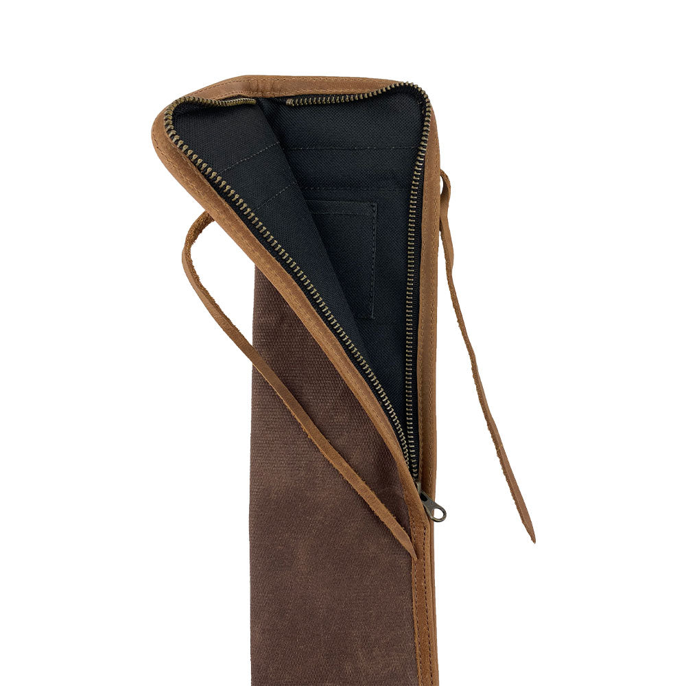 Close-up view of the brown Hide & Drink Drummstick Bag, showcasing its fine materials of Waxed Canvas & Full Grain Leather. This stylish Drumstick Bag Holder is perfect for drummers, reflecting the high quality artisanal craftsmanship from small batch production in La Antigua Guatemala & Oaxaca Mexico.