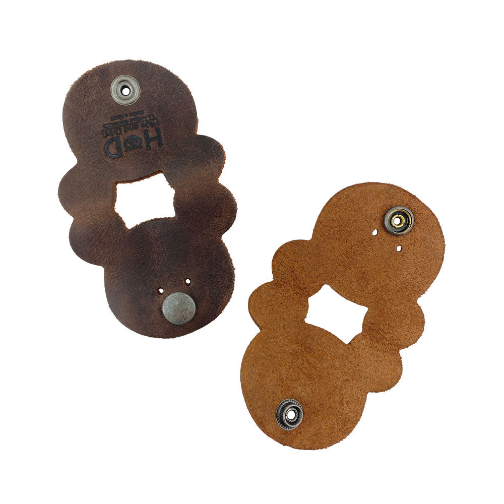 Two Bear Shaped Cord Keepers (Cord Clam) by Hide & Drink, featuring a unique design, made from durable Full Grain Leather, perfect for organizing cords. Handmade in La Antigua Guatemala & Oaxaca Mexico, showcasing small batch production.