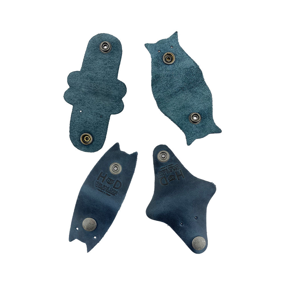 Furry Friends Cord Keeper (4-Pack) with delightful animal shapes, made from premium full grain leather by Hide & Drink, ideal for keeping cords organized. Furry Friends 4-Pack Cord Keeper (Cord Clam), Full Grain Leather, StockyardX, Small Batch Production, Hand Cut, Hand Sewn, Fire Branded, Artisan, Handmade in La Antigua Guatemala & Oaxaca Mexico.