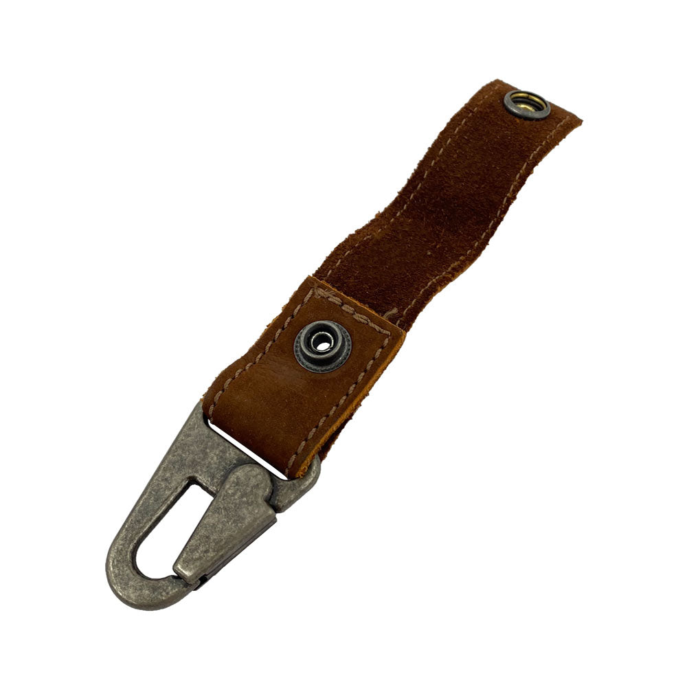 Side view of the Key Ring Holder by Hide & Drink displaying the unique details of its Full Grain Leather construction. This Key Ring Holder showcases Small Batch Production with meticulous Hand Cut and Hand Sewn features, proudly displaying a Fire Branded logo. A remarkable Artisan creation, Handmade in La Antigua Guatemala & Oaxaca Mexico.